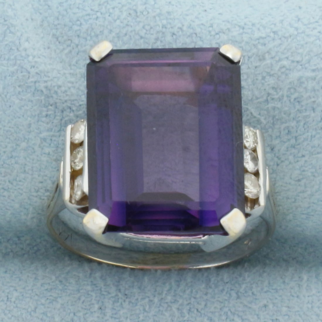 Amethyst and Diamond Statement Ring in 14k White Gold: In 14k White Gold. Contains one 16x12mm high quality emerald cut natural Amethyst gemstone, approximately 8cts, with intense color and excellent clarity. Also contains six .03ct high quality diamonds,