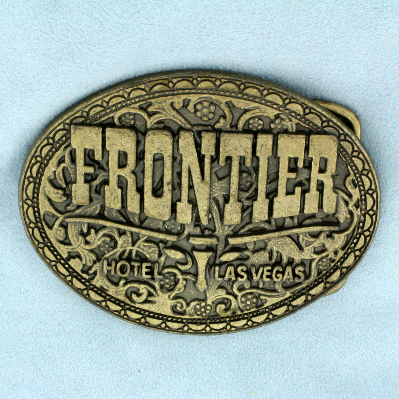 Vintage Frontier Hotel Casino Las Vegas Brass Belt Buckle: In Brass. 3 1/4 inches long. 2 1/2 inch wide. Unique vintage find.