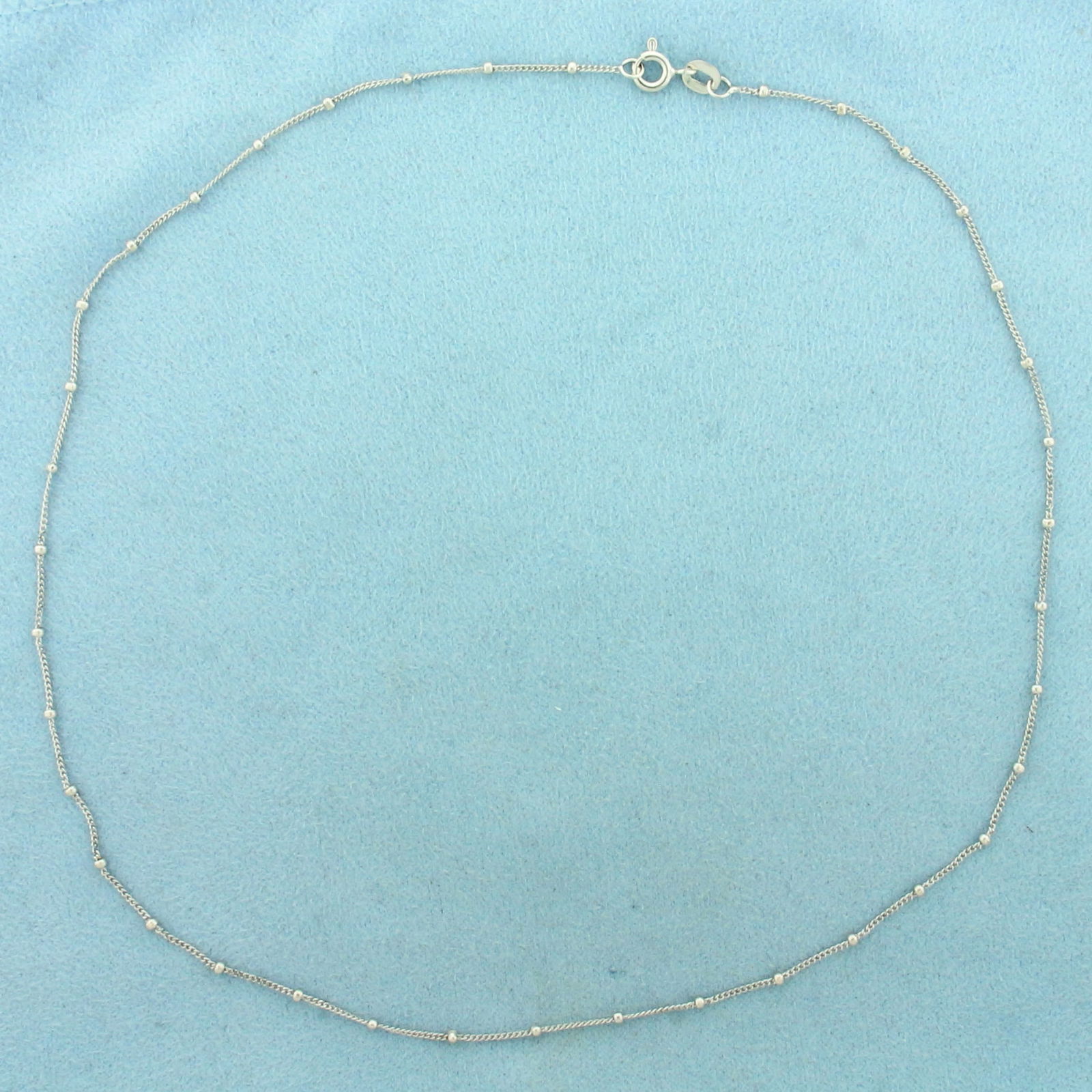 16 Inch Curb Link Ball Bead Station Necklace in 18k White Gold: In 18k White Gold. 16 inches long. 1.5mm ball beads. Spring clasp. 2.3g.