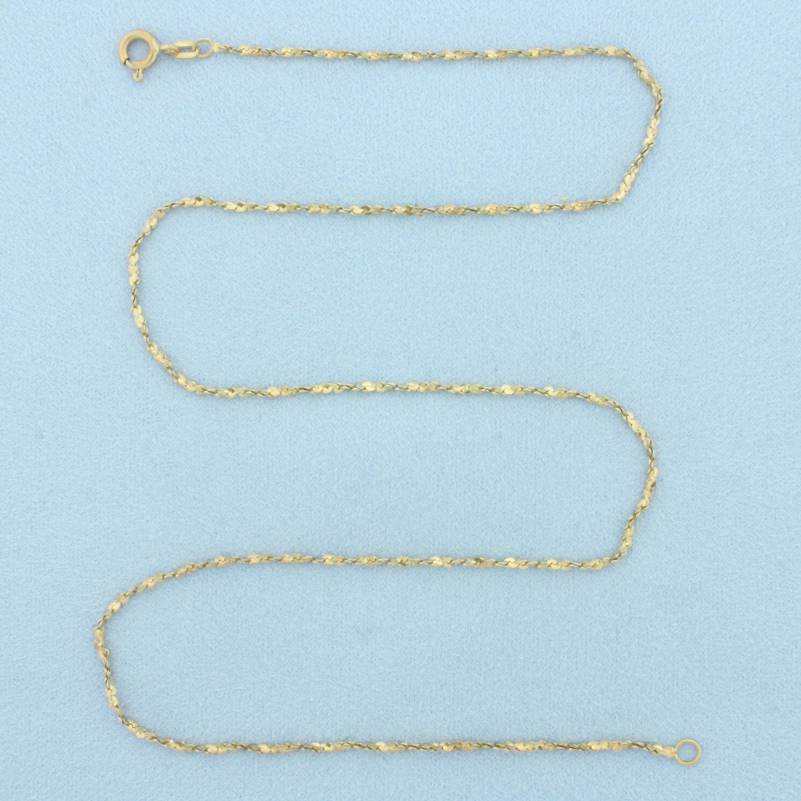 18 Inch Italian Twisting S-Link Chain Necklace in 14k Yellow Gold: In 14k Yellow Gold. 18 inches long. 1.4mm wide. Made in Italy. Spring clasp. 3.4g.