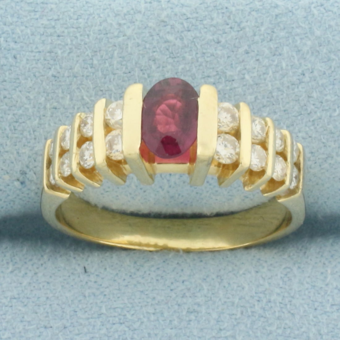 Garnet and Diamond Ring in 14k Yellow Gold: In 14k Yellow Gold. Contains one 6.5mm high quality natural Garnet gemstone with intense color and excellent clarity. Also contains four .06ct, eight .04ct, and four .03ct high quality diamonds, SI cl