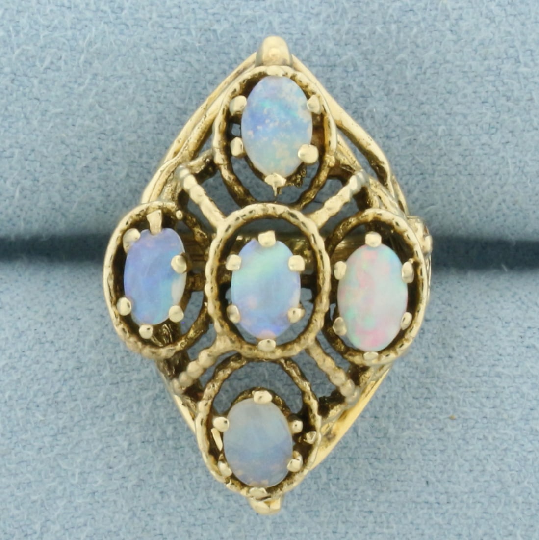 Vintage Opal Statement Ring in 14k Yellow Gold: In 14k Yellow Gold. Contains five 6x4mm high quality natural Opal gemstones with excellent play of color - flashes of blue, green, red, and orange. Size 4. 7.4g.