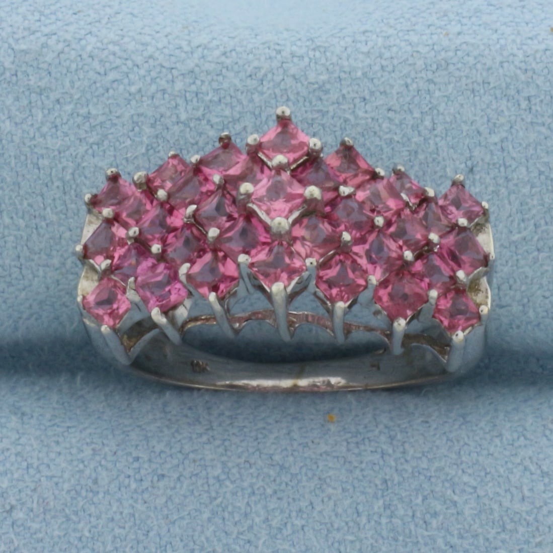 Pink Tourmaline Statement Ring in 10k White Gold: In 10k White Gold. Contains thirty-three 2.5mm high quality princess cut natural Pink Tourmaline gemstones, approximately 2ct TW, with vibrant color and excellent clarity. 11mm wide at center top of r