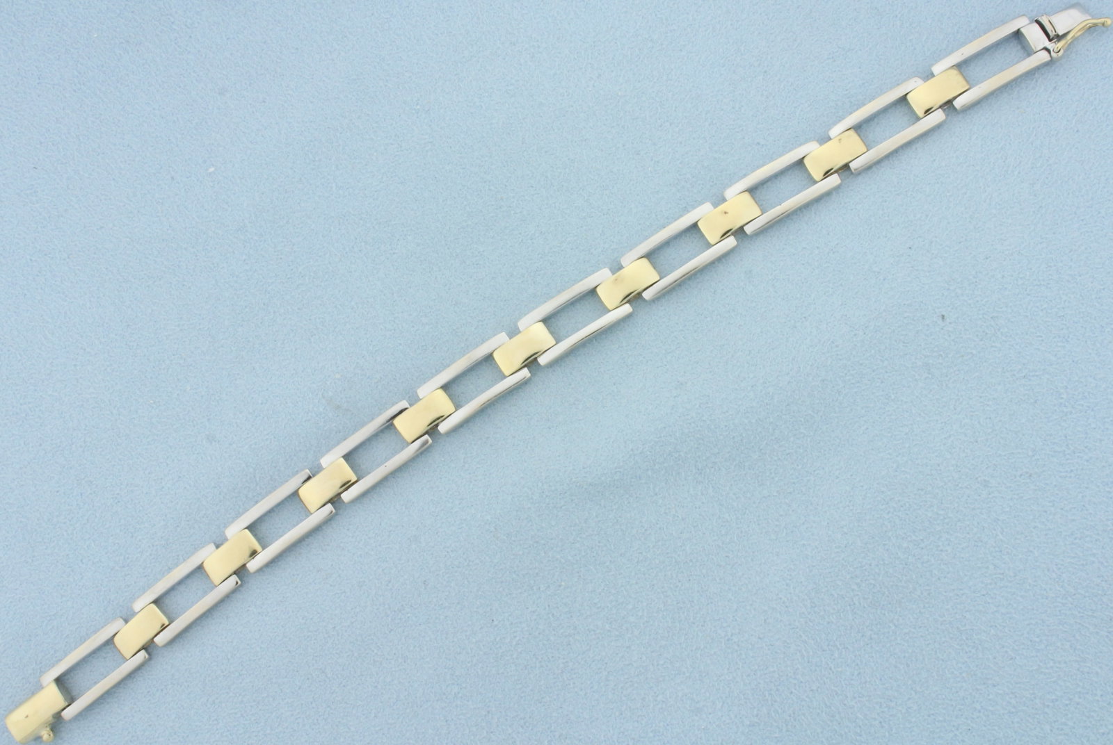 Two Tone Tank Tread Link Bracelet in 14k Yellow and White Gold: In 14k yellow and white gold. 7 1/2 inches long and 8.3mm wide. Safety clasp. 23.8g.