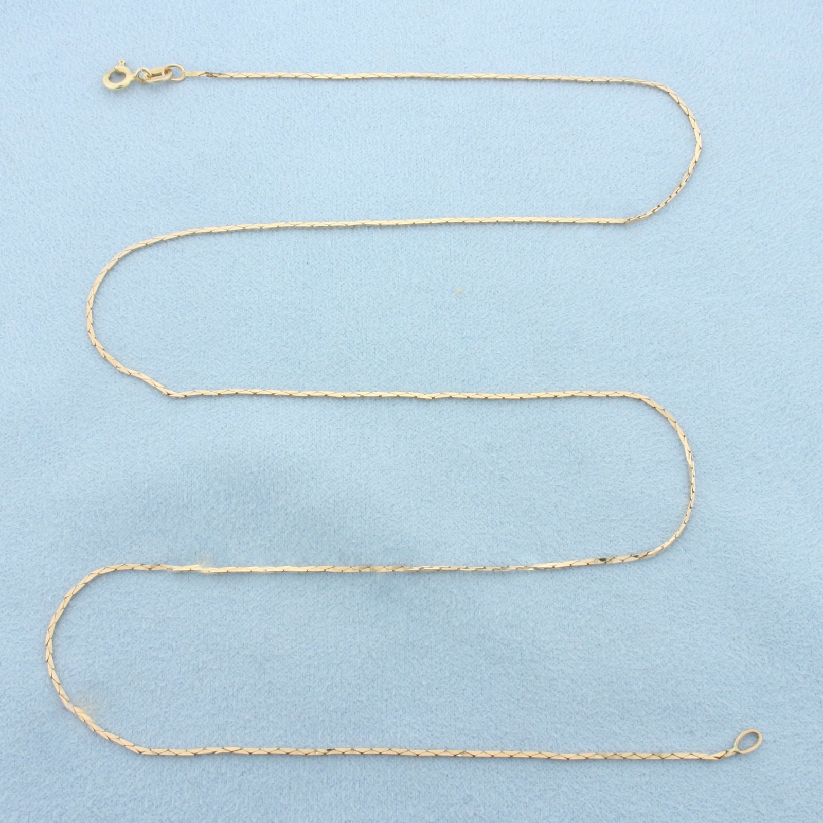 21 Inch Italian Cobra Link Chain Necklace in 14k Yellow Gold: In 14k Yellow Gold. 21 inches long. 0.8mm wide. Made in Italy. Spring clasp. 2.4g.