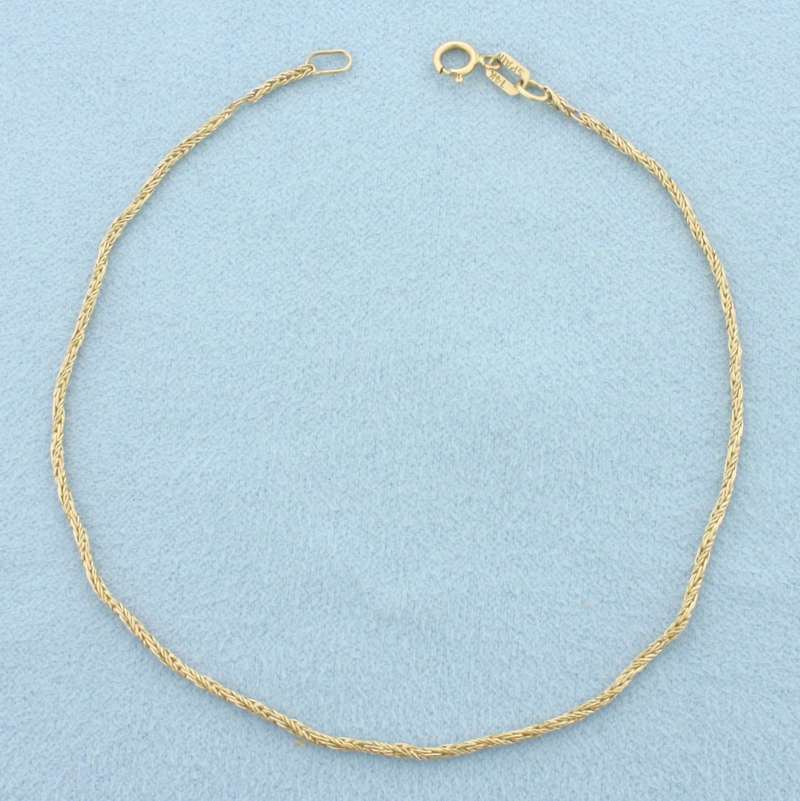 Wheat Link Bracelet in 14k Yellow Gold: In 14k Yellow Gold. 8 inches long. 1.1mm wide. Spring clasp. 1.3g.