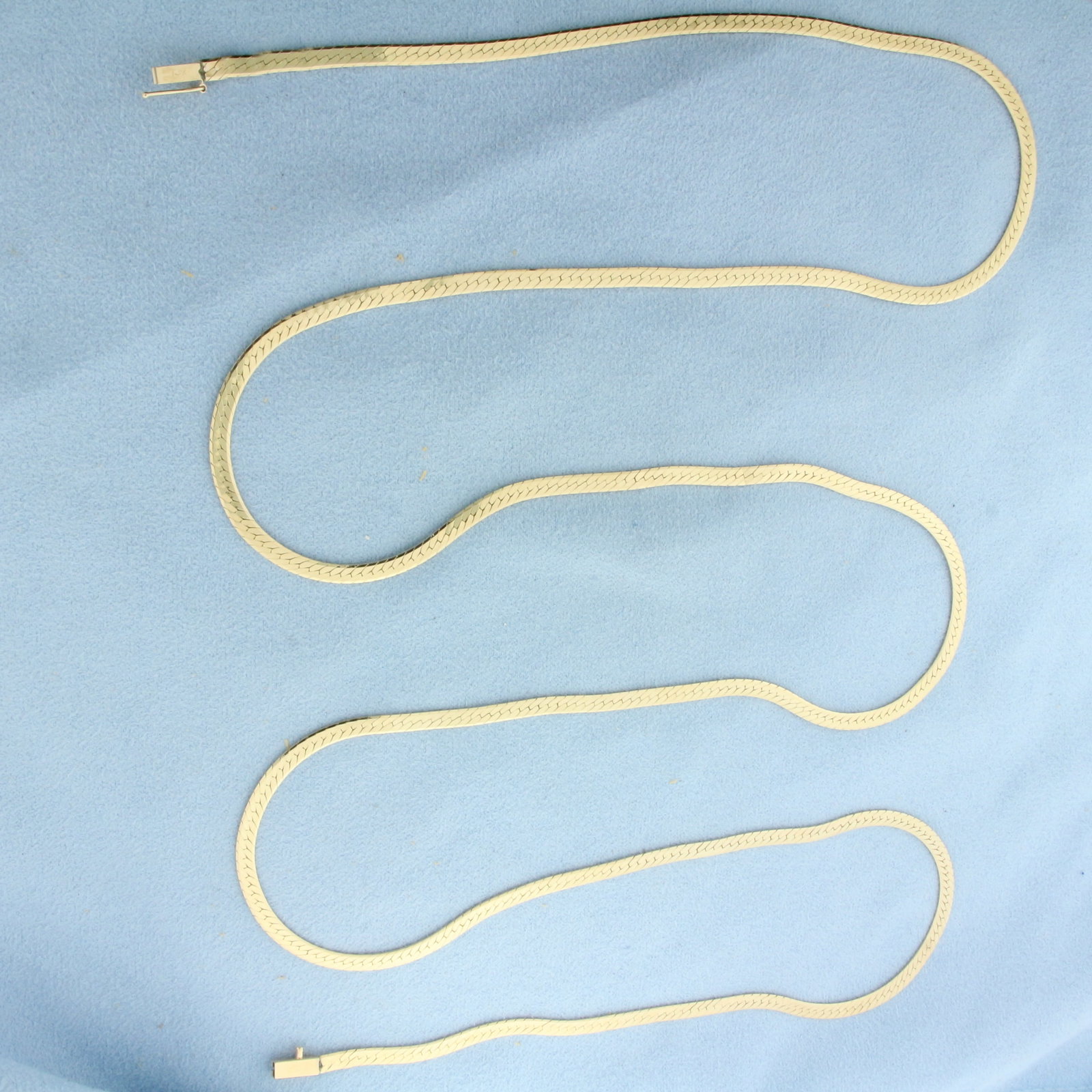 36 Inch Herringbone Link Chain Necklace in 14k Yellow Gold: In 14k Yellow Gold. 36 inches long. 3mm wide. Slide clasp with safety latch. 17.5g.