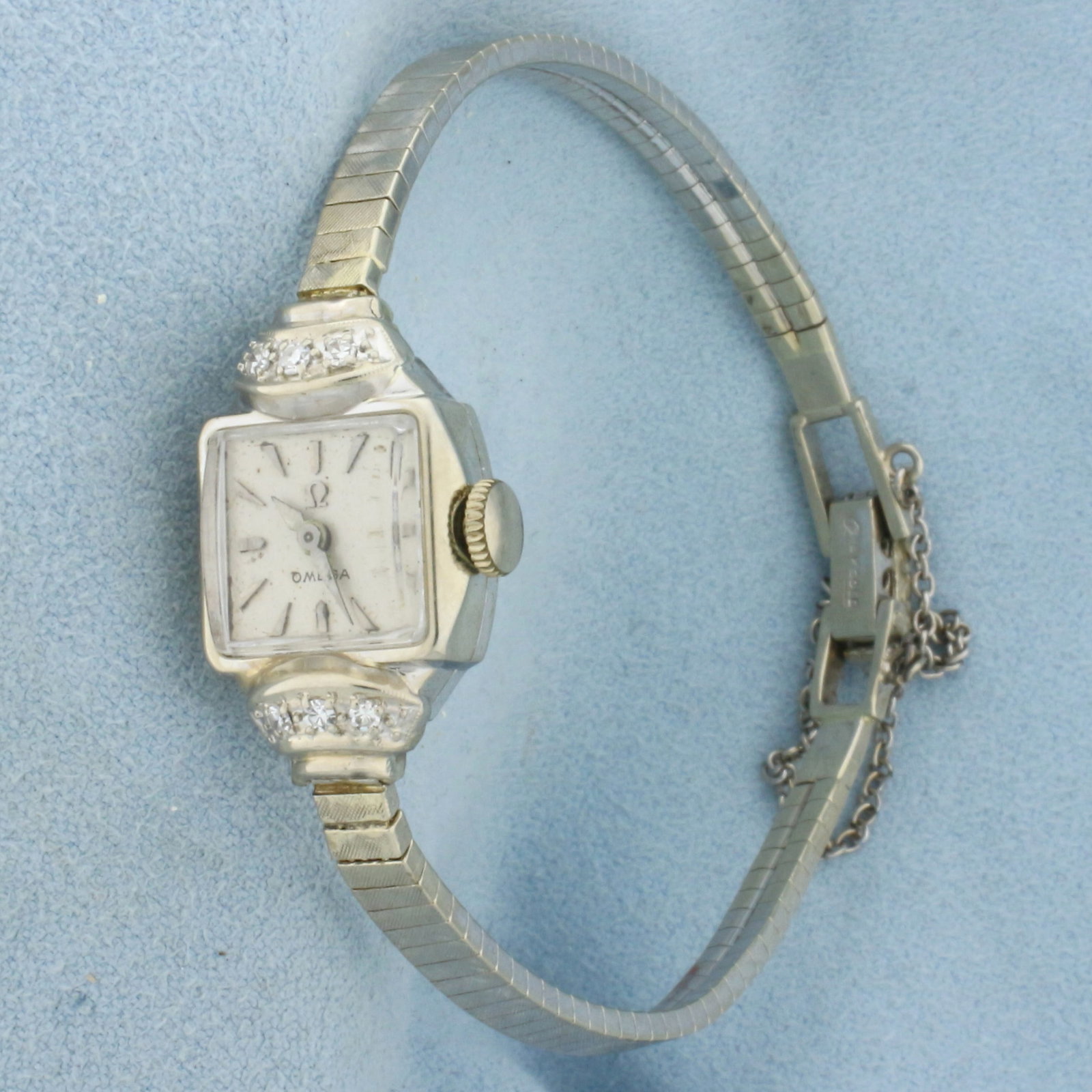 Womans Vintage Omega Wrist Watch in Solid 14K White Gold: Case and Band in Solid 14K White Gold. Windup movement runs great. Watch in great condition with minor scratching on crystal and band, indicative of age. Contains six high quality .01ct Diamonds in ca