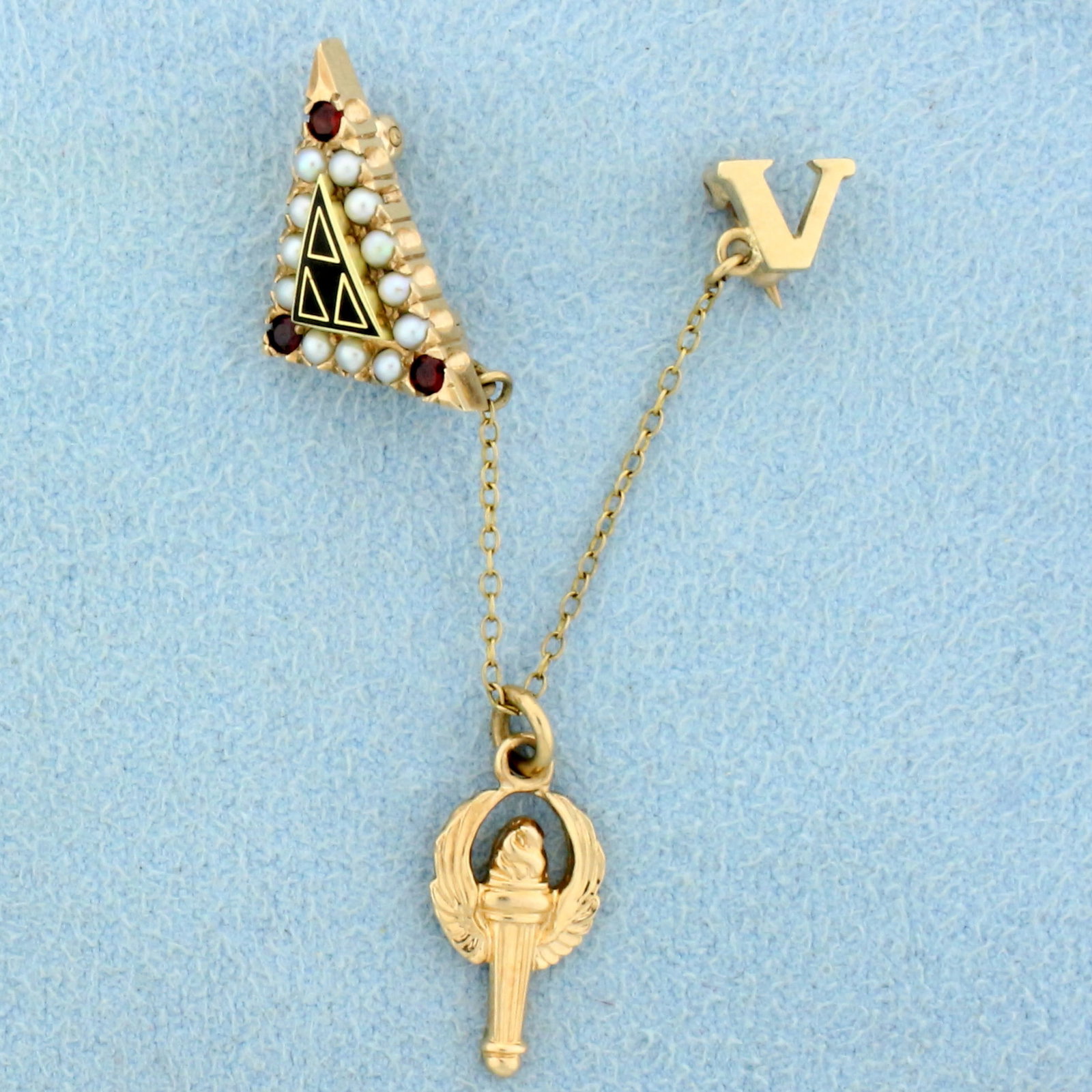 Vintage Acacia Fraternity Pin in 10K Yellow Gold: In 10K Yellow Gold. Contains three high quality natural 1.5mm Garnet gemstones. Also contains twelve high quality natural 1.5mm Pearls. 3 inches long. 3.7g.