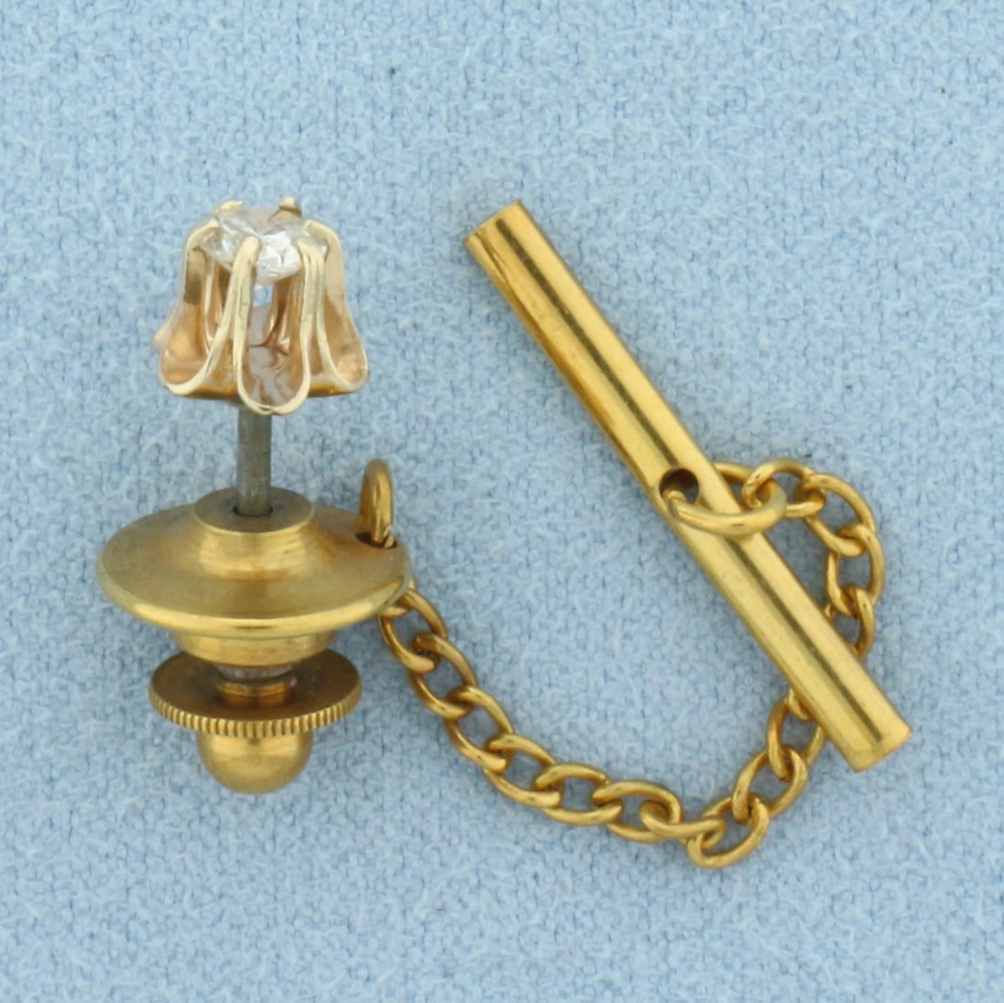 Diamond Buttercup Solitaire Tie Tack Pin in 14k Yellow Gold: 14k yellow gold head. Contains one high quality 1/4ct diamond, SI clarity/H color. Buttercup 6-prong design. 3.3g.