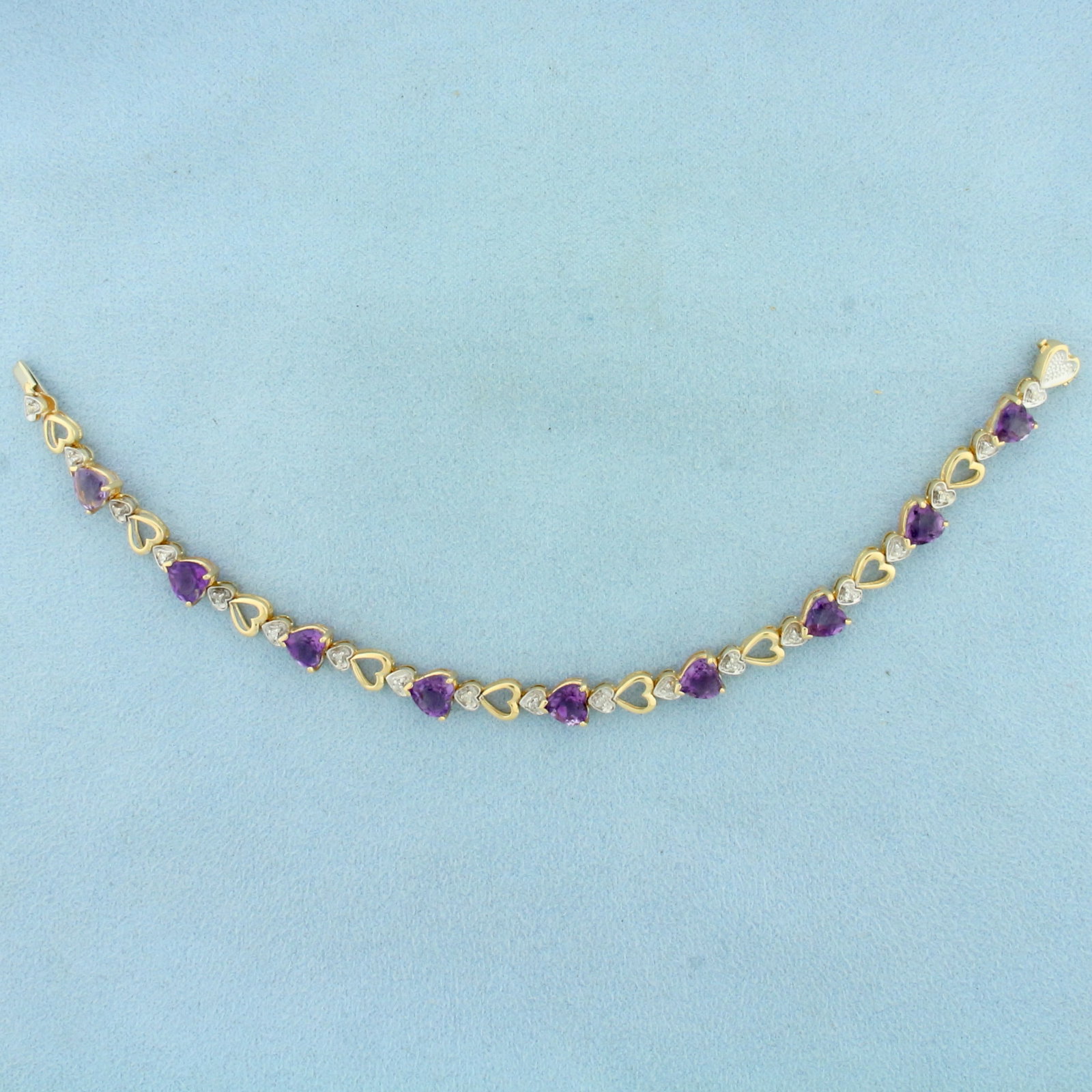 Heart Amethyst and Diamond Tennis Bracelet in 14k Yellow Gold: In 14k Yellow Gold. Contains nine 6mm high quality natural heart shaped Amethyst gemstones with vibrant color and excellent clarity. Also contains nineteen high quality 1/2pt high quality diamonds. 7