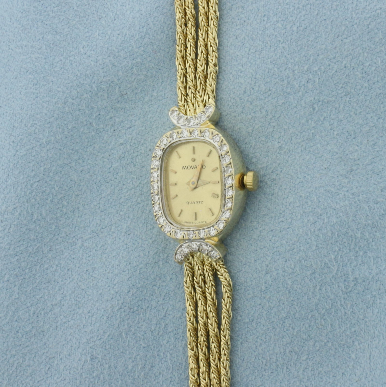 Vintage Movado Diamond Rope Bracelet Watch in Solid 14k Yellow Gold: Case and bracelet in solid 14k yellow gold. 7 inches long. Case is 20mm long by 15mm wid. Contains .43ct TW of high quality diamonds in bezel.. Quartz movement runs great, new battery. Stamped D43, 79