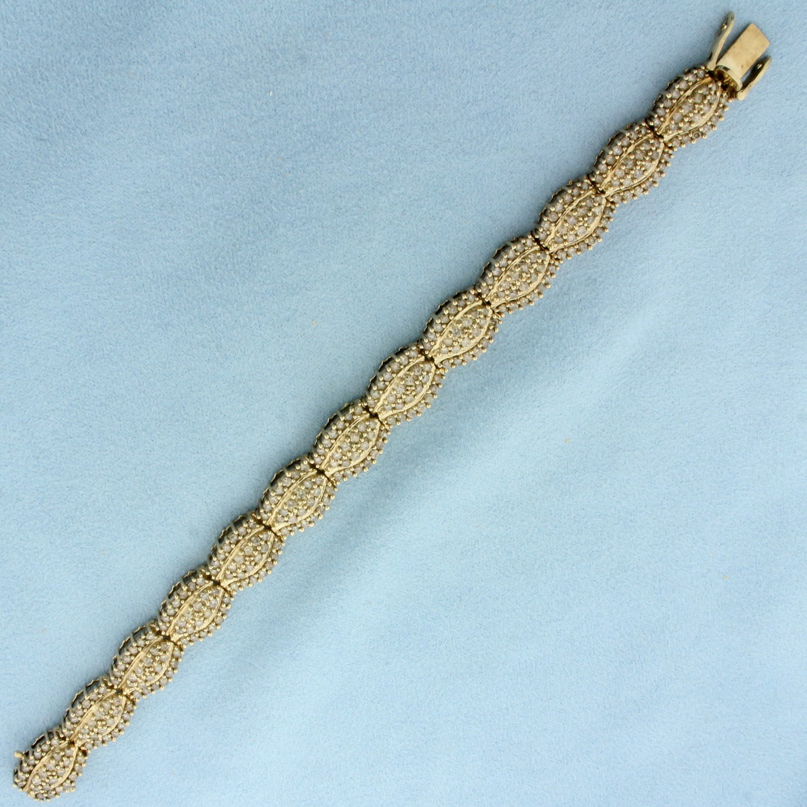 Champagne Diamond Bracelet in 10k Yellow Gold: In 10k Yellow Gold. Contains three hundred and twelve high quality champagne diamonds, 9ct TW/ 7 1/8 inches long. 11mm wide. Concealed slide clasp with two safety latches. 20.9g.