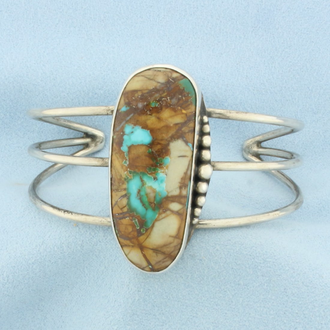 Signed J. Hayes Navajo Turquoise Cuff Bracelet in Sterling Silver: In .925 Sterling Silver. Contains one 1 5/8 inch tall by 1/2 inch wide high quality turquoise gemstone. Interior dimensions: 2 1/2 inch by 1 5/8 inch. 1 5/8 inch wide at center. 27.5g.
