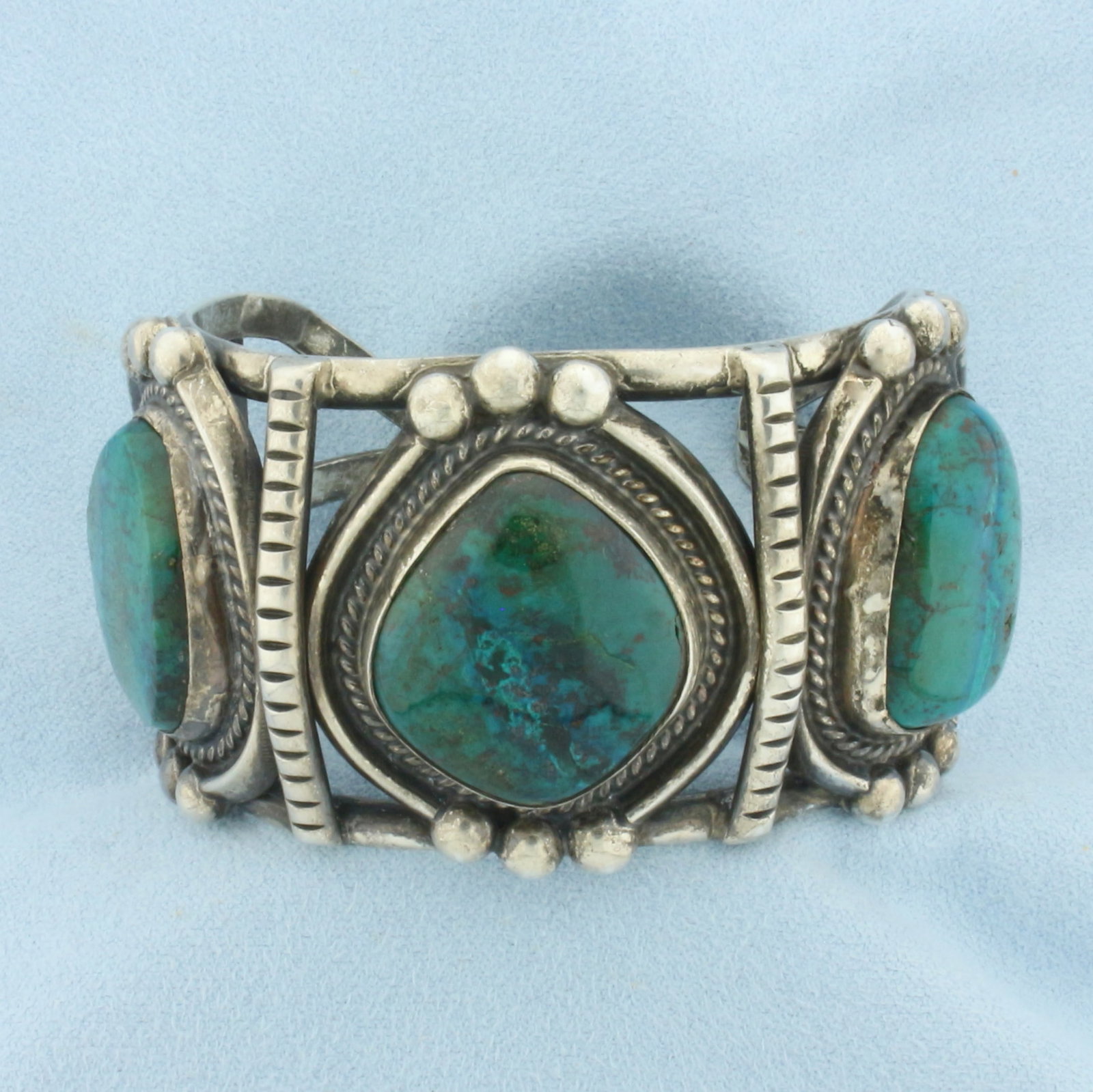 Heavy Turquoise Signed Cuff Bracelet in Sterling Silver: In .925 Sterling Silver. Contains three high quality turquoise gemstones. Interior dimensions: 2 1/4 inch by 2 inch. 1.5 inches wide. Signed "JP". 106.7g.