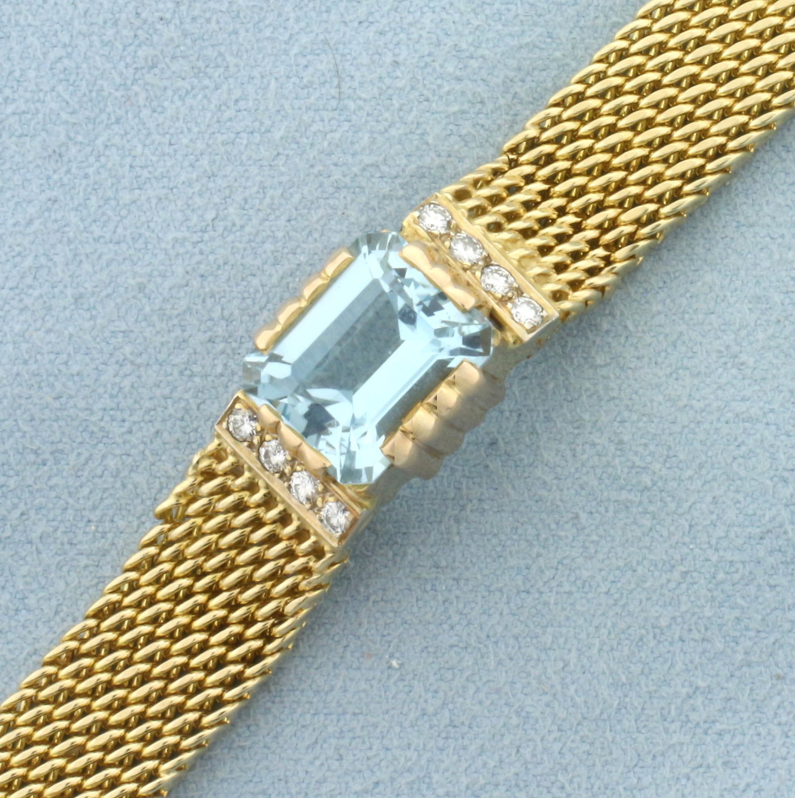 Vintage Aquamarine and Diamond Statement Bracelet in 14k Yellow and Rose Gold: In 14k yellow gold with rose gold accents. Contains one high quality natural emerald cut 5.5ct Aquamarine gemstone with beautiful color and excellent clarity. Also contains 8 high quality round brilli