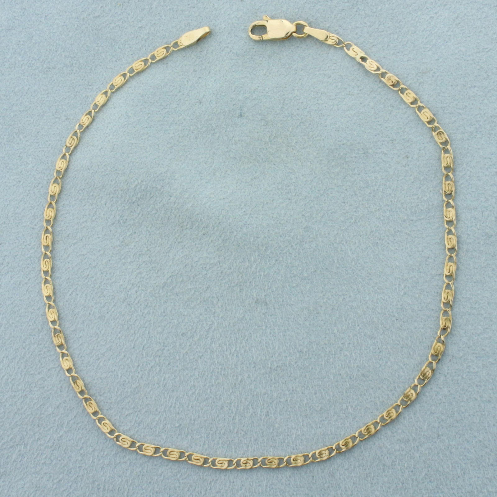 Paperclip Scroll Link Anklet in 14k Yellow Gold: In 14k Yellow Gold. 9 7/8 inches long. 2mm wide. Lobster clasp. 2.8g.