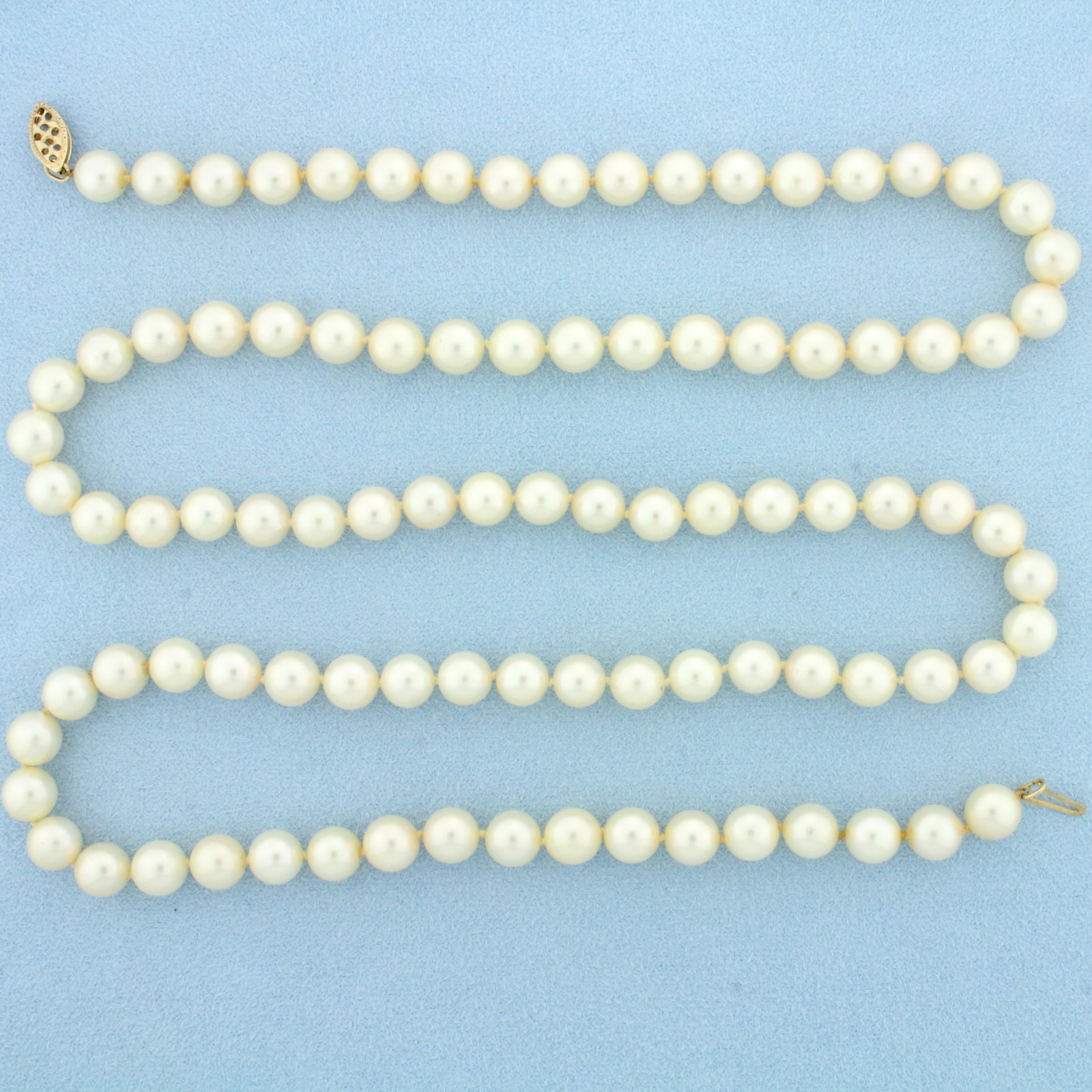 29 Inch Akoya Pearl Strand Necklace in 14K Yellow Gold: 14K Yellow Gold clasp. 29 inches long. Contains ninety three very high quality 7mm cultured Akoya Pearls, creamy pink undertone, beautiful nacre. 50.8g.