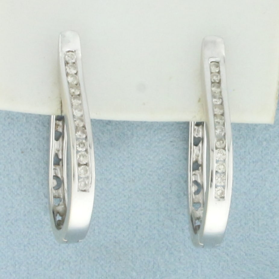Reversible Diamond Sun Moon Stars Hoop Earrings in 14k White Gold: In 14k white gold. Contains 24 high quality diamonds, 1/2ct TW, SI clarity/I color. 1 1/8 inches long x 3/4 inches wide. Star, heart, moon design on other side of earrings, can be worn showing either