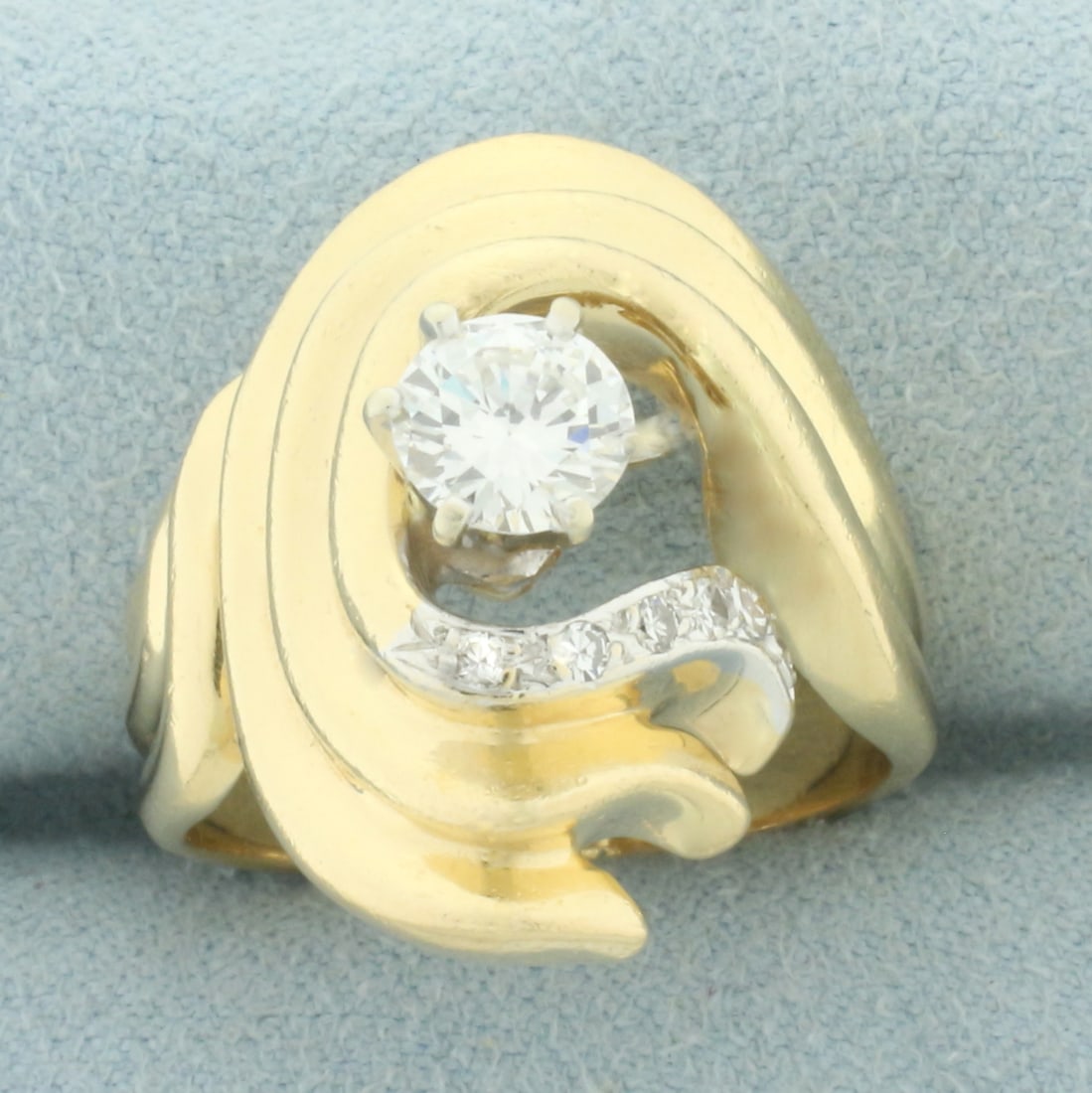 Diamond Swoop Design Ring in 14k Yellow Gold: In 14k yellow gold. Contains one high quality 3/4ct round brilliant diamond, VS clarity/G color. Also contains six high quality .01ct diamonds of similar high quality. 22mm wide at center of ring. Siz
