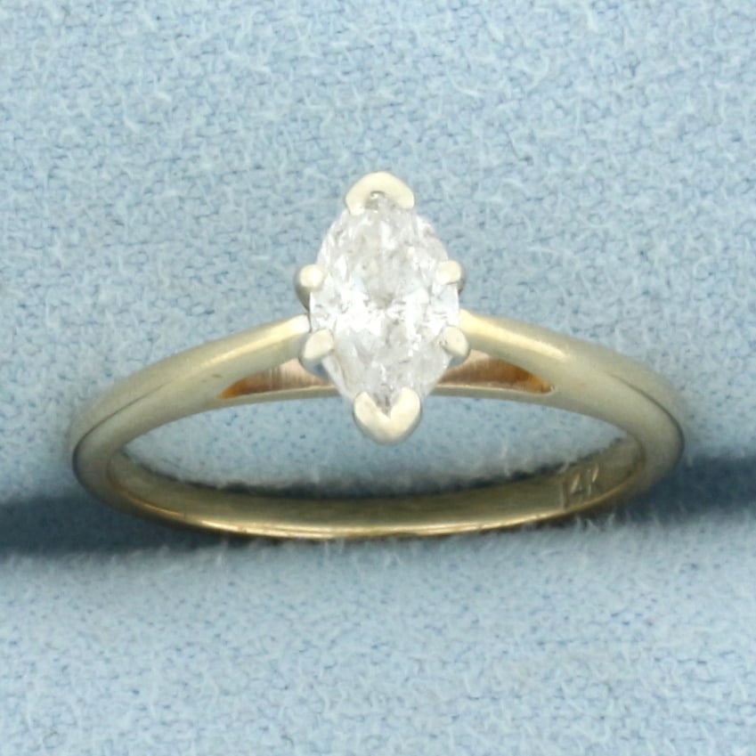 Marquise Diamond Solitaire Engagement Ring in 14k Yellow Gold: In 14k Yellow Gold. Contains one 8mmx4.4mm marquise diamond, 3/4ct , H color/I clarity, eye clean. Cathedral style setting. Size 6. 2.2g.