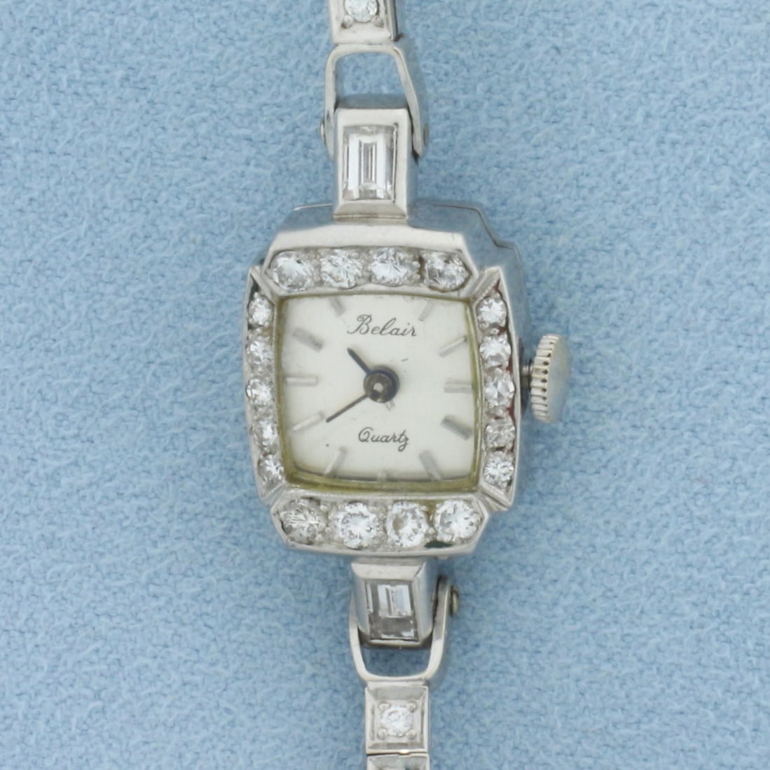 Vintage Womans Belaire Diamond Watch in 14k White Gold: Case and Band In Solid 14k White Gold. Quartz movement runs great, new battery. 17mm by 14mm case, 6 1/8 inches long. Contains 1ct TW of high quality round and baguette diamonds, VS clarity/G color.