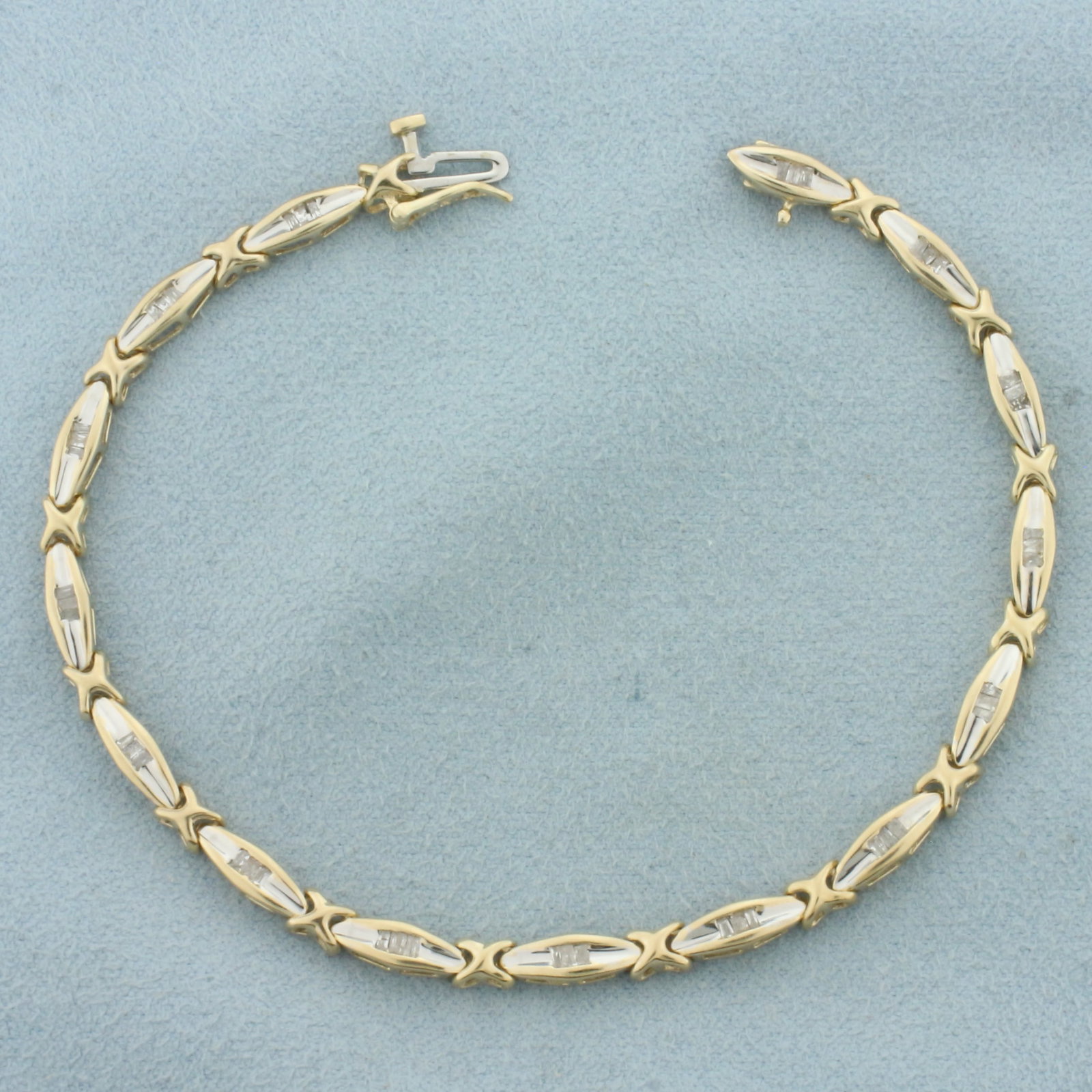 Baguette Diamond Tennis Bracelet in 10k Yellow Gold: In 10k Yellow Gold. Contains forty-five high quality baguette diamonds, 1/2ct TW, I color/I clarity. 7 3/8 inches long. 1/8 inch wide. Concealed slide clasp with safety latch. 7.0g.