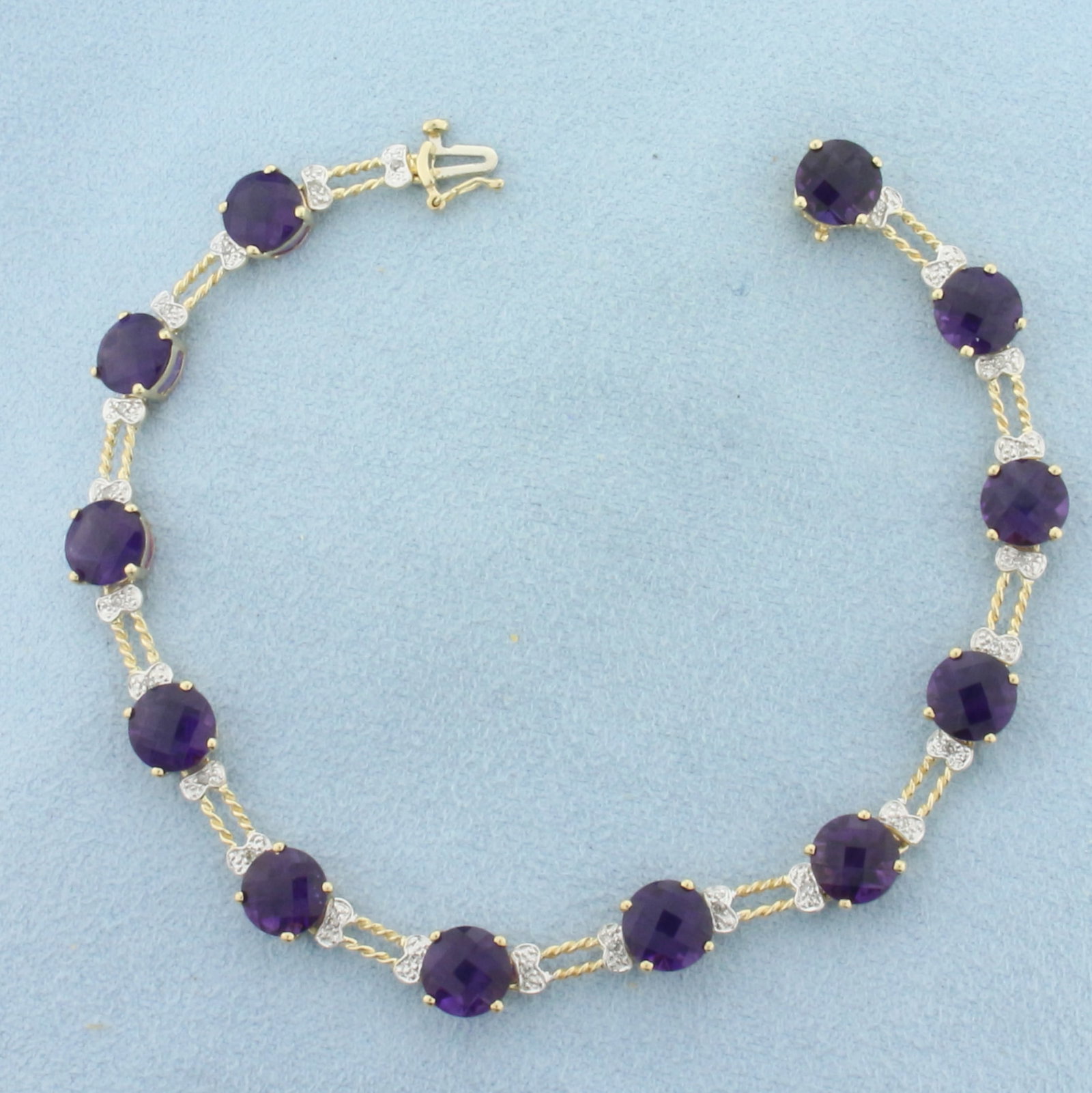 Checkerboard Cut Amethyst and Diamond Tennis Bracelet in 10K Yellow Gold: In 10k yellow gold. Measures 7.5 inches long. Contains 12 high quality natural 7mm fancy checkerboard cut Amethyst Gemstones, approximately 14ct TW, with vibrant color and excellent clarity. Also cont