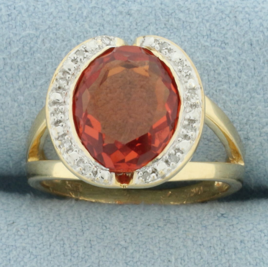 Mexican Fire Opal and Diamond Ring in 10k Yellow Gold: In 10k Yellow Gold. Contains one 12x10mm high quality oval cut natural Mexican Fire Opal gemstone, approximately 5cts, with intense color and excellent clarity. Also contains ten high quality 1/2pt di