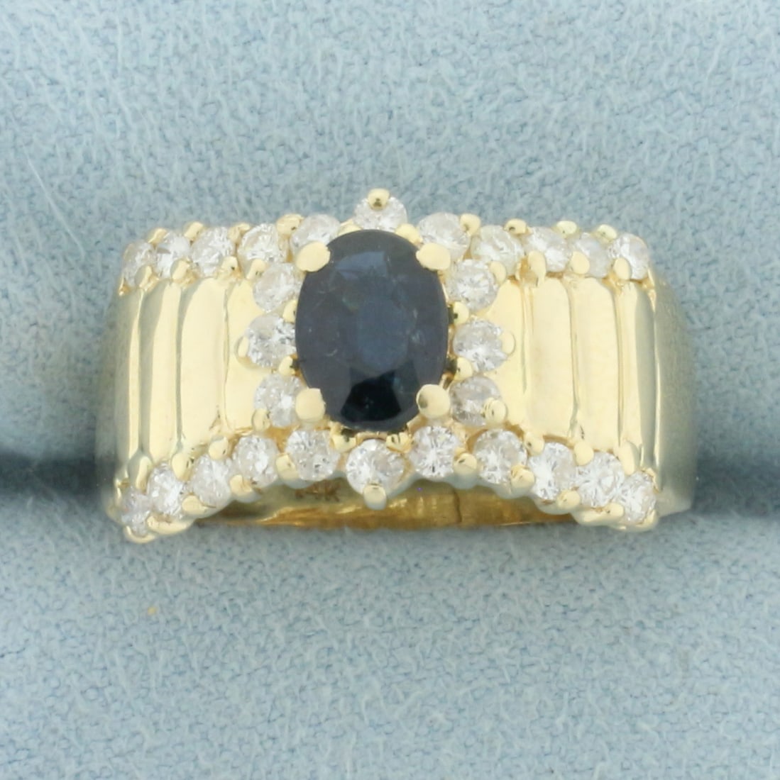 Natural Sapphire and Diamond Ring in 14k Yellow Gold: In 14k yellow gold. Contains one high quality natural 7mm by 5mm oval cut sapphire with deep blue color and excellent clarity. Accented by 28 high quality diamonds, 3/4ct TW, SI clarity/G color. Size: