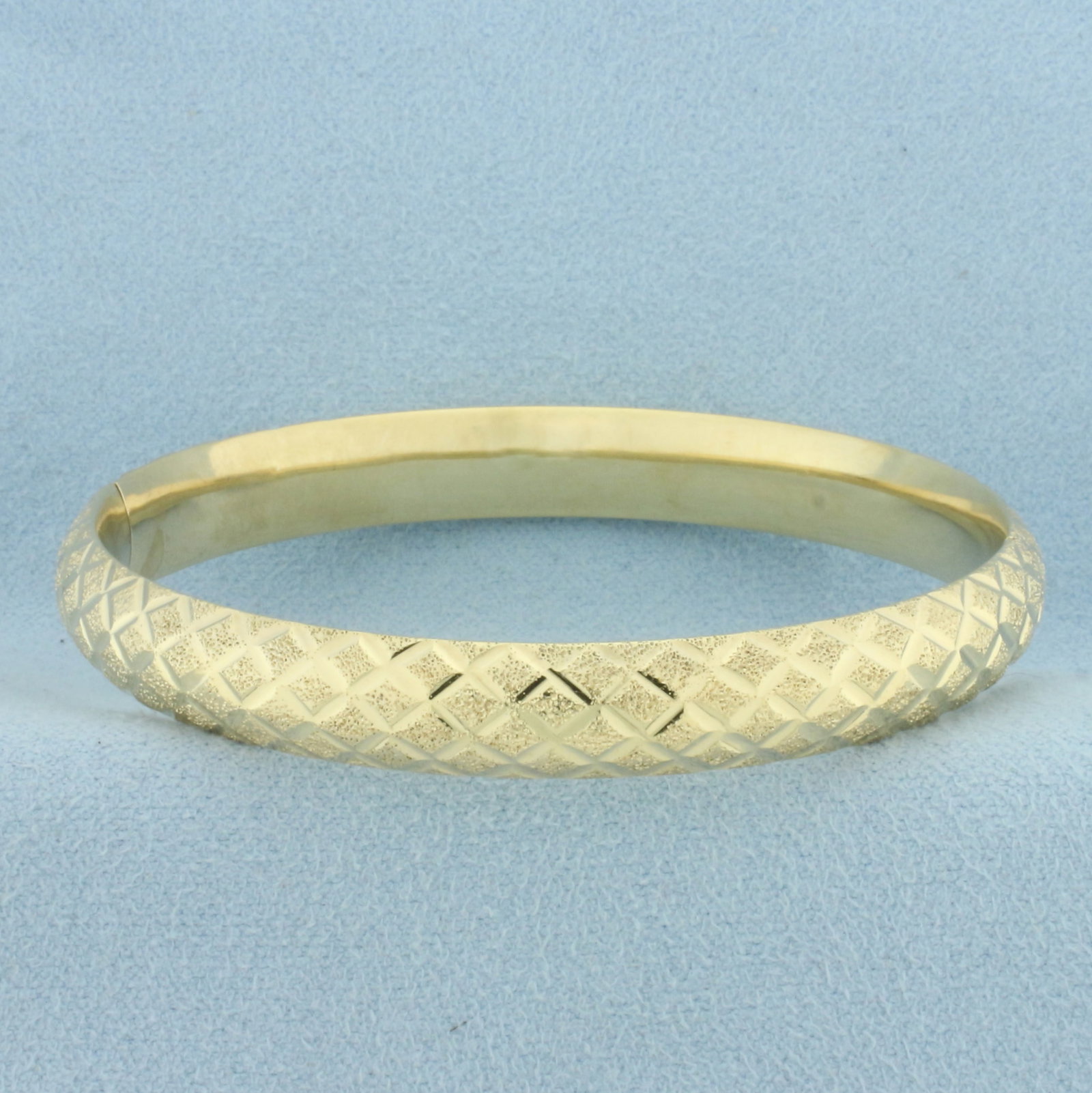 Diamond Cut Sandblast Hinged Bangle Bracelet in 14k Yellow Gold: In 14k yellow gold. Sandblast and diamond cut details. 8.5mm wide. Hinged slide closure. 10.1g.