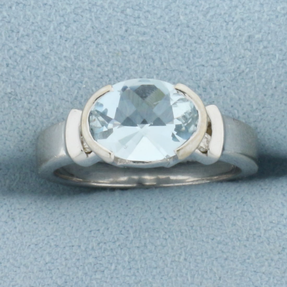Aquamarine and Diamond Ring in 14k White Gold: In 14k White Gold. Contains one 2ct high quality fancy oval cut Aquamarine gemstone with bright color and excellent clarity. Also contains four .01ct high quality diamonds, SI clarity/H color. Size 5.
