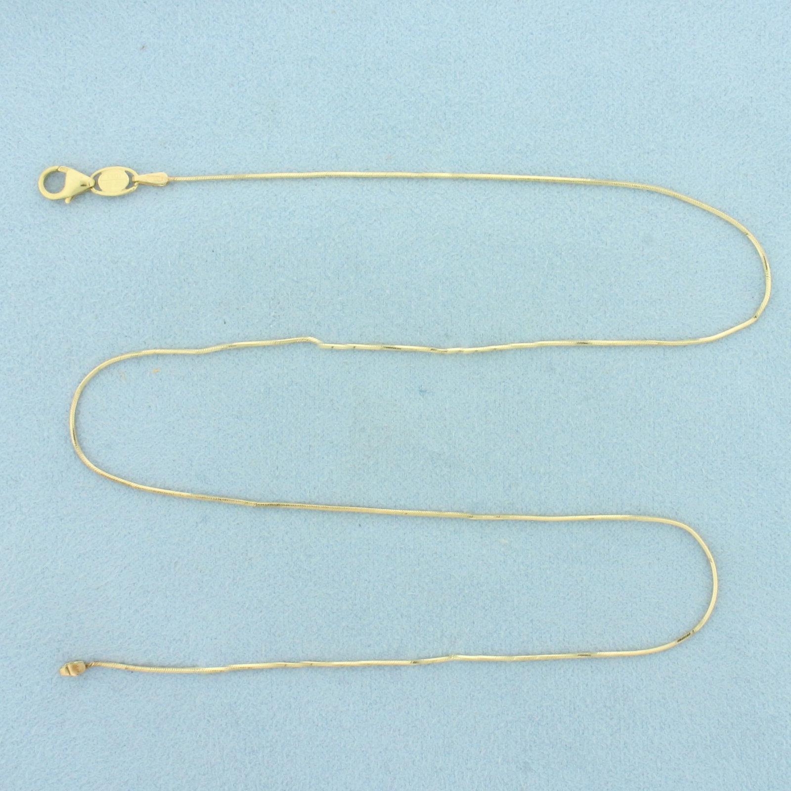 Italian 16 Inch Snake Link Chain Choker Necklace in 14k Yellow Gold: In 14k Yellow Gold. 16 inches long. 0.7mm wide. Italian made. Lobster clasp. 2.5g.