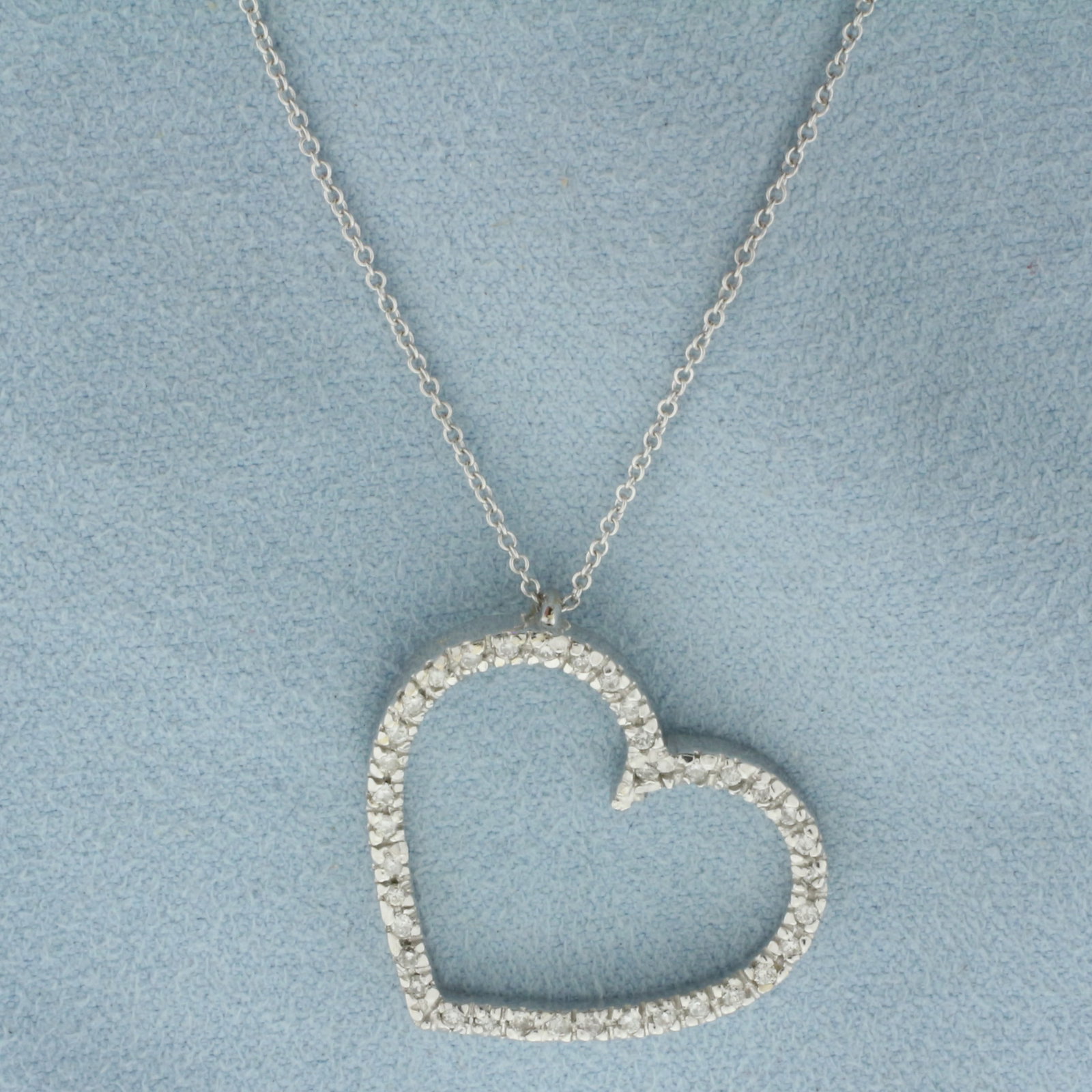 Diamond Heart Necklace in 18k White Gold Heart and 14k White Gold Chain: 18k White Gold Heart and 14k White Gold Chain. Contains thirty-seven high quality diamonds, 1/2ct TW, SI clarity/G color. 1 inch by 1 inch pendant. 18 inch long chain. 1mm wide. Lobster clasp. 5.9g.