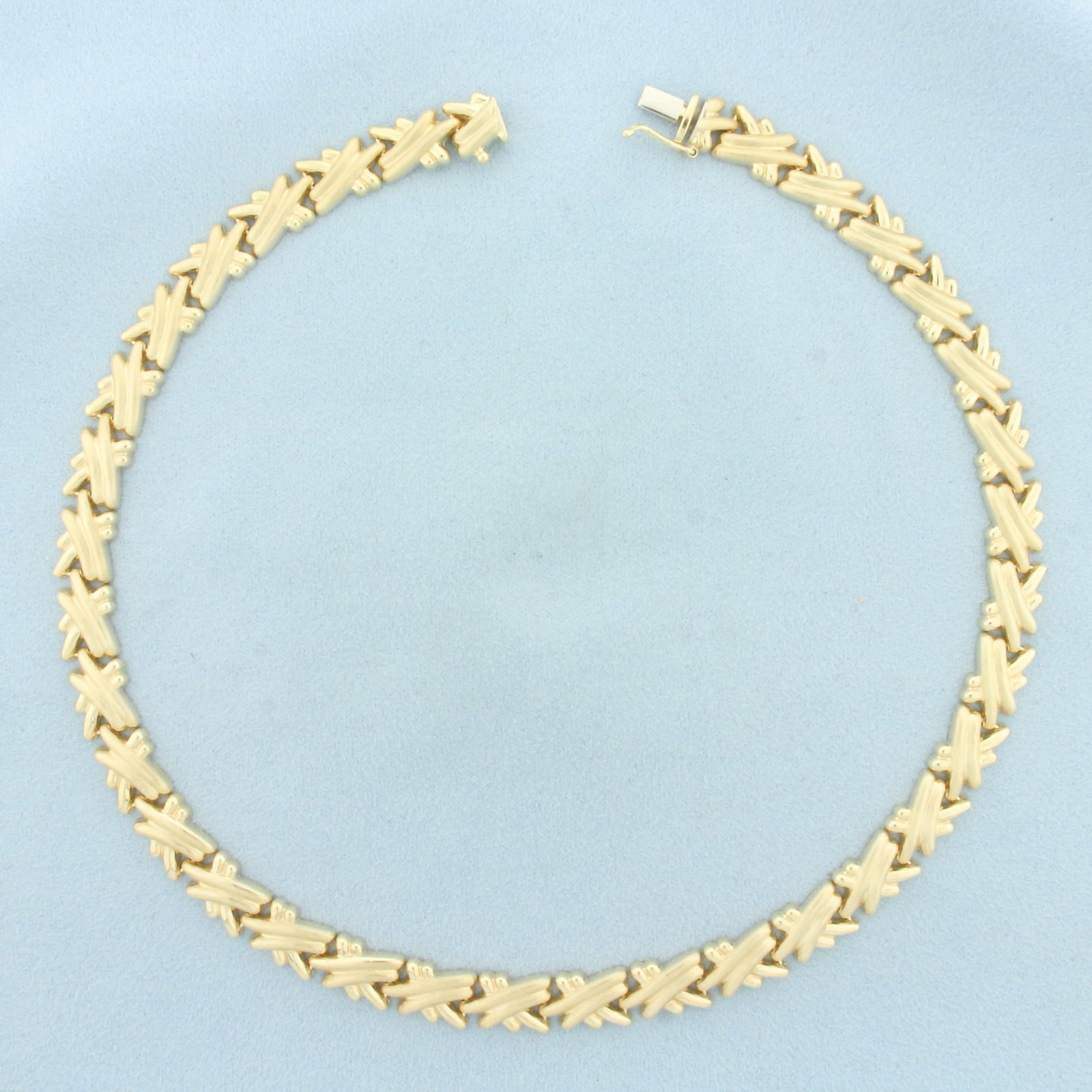 Italian 16 Inch Criss Cross Link Choker Necklace in 14k Yellow Gold: In 14k Yellow Gold. 16 inches long. 9mm wide. Italian made. Slide clasp with safety latch. 23.4g.