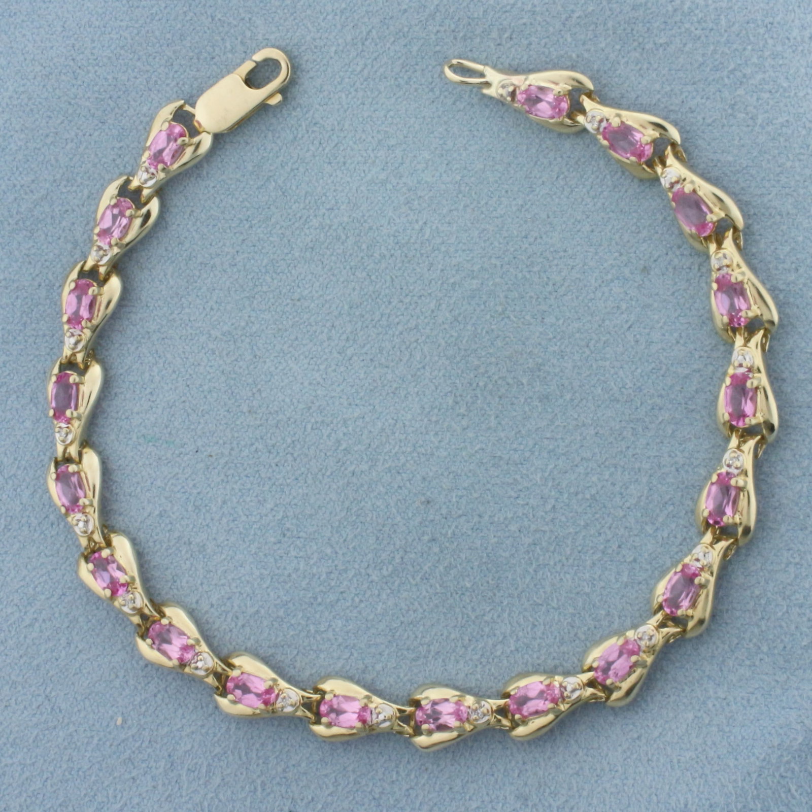 Pink Topaz and Diamond Bracelet in 14k Yellow Gold: In 14k Yellow Gold. Contains nineteen 3x5mm high quality natural Pink Topaz gemstones, approximately 5ct TW, with vibrant color and excellent clarity. Also contains nine high quality 1/2pt diamonds. 8