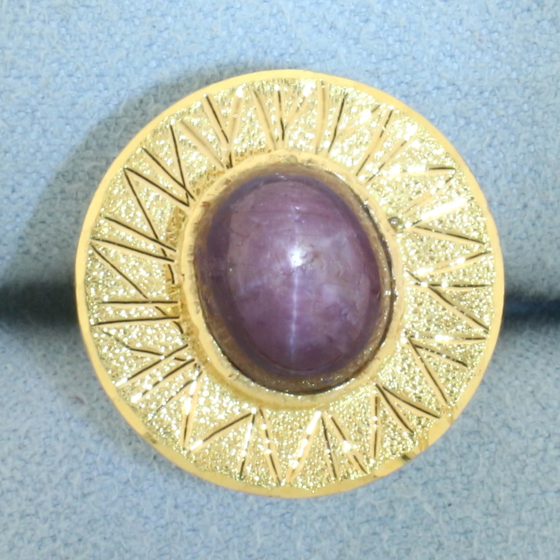 Star Ruby Ring in 22k Yellow Gold: In 22k Yellow Gold. Contains one 10x8.2mm high quality natural Star Ruby gemstone, approximately 6cts, with very distinctive "star" under light. 16.1mm wide at top. Size 6.25. 9.3g.