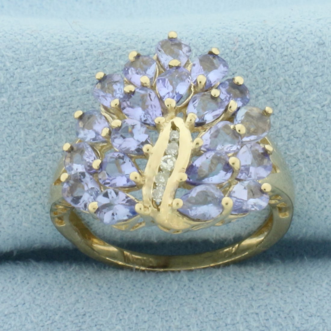 Tanzanite and Diamond Ring in 10k Yellow Gold: In 10k Yellow Gold. Contains twenty 4x3mm high quality pear cut natural Tanzanite gemstones with bright color and excellent clarity. Also contains five high quality .01ct diamonds, SI clarity/I color.