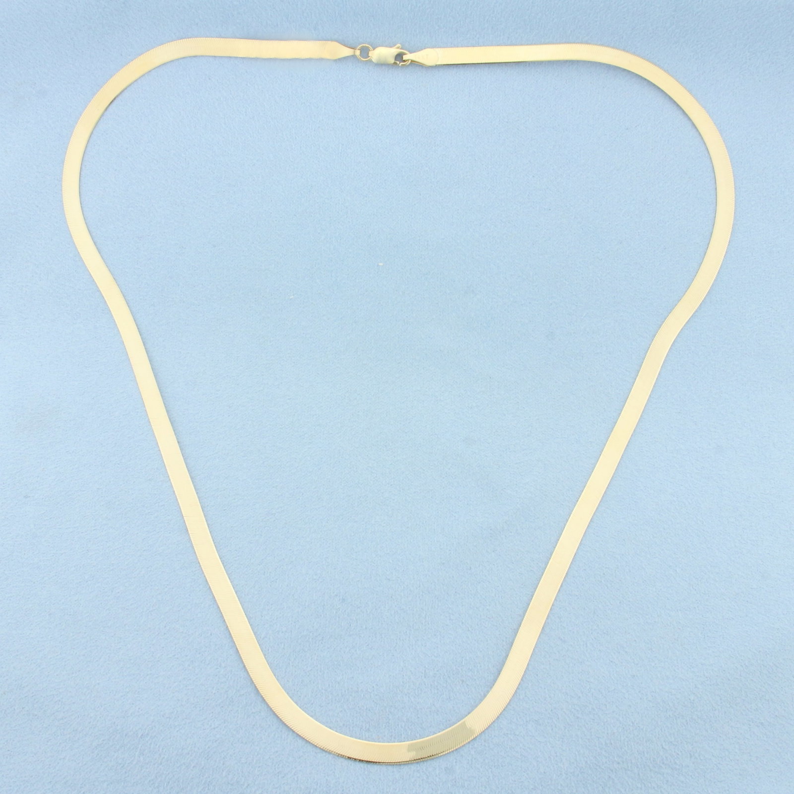 20 Inch Liquid Gold Herringbone Link Chain Necklace in 14k Yellow Gold: In 14k Yellow Gold. 20 inches long. 4.1mm wide. Lobster clasp. 7.0g.