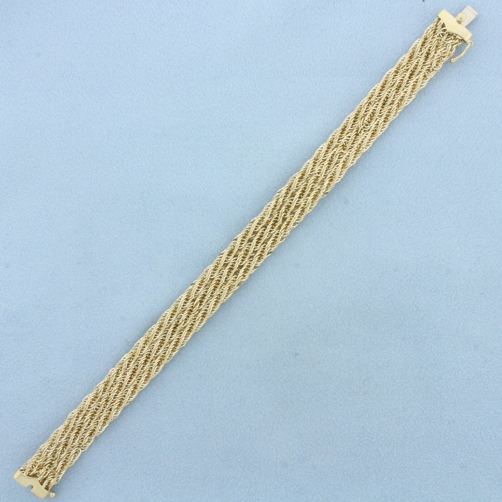 Wide Triple Rope Link Bracelet in 14k Yellow Gold: In 14k Yellow Gold. 7 3/8 inches long. 10.8mm wide. Slide clasp with safety latch. 9.1g.