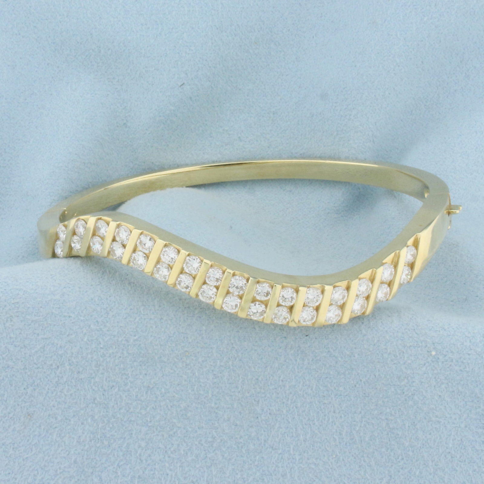 3ct TW Diamond Wave Design Bangle Bracelet in 14K Yellow Gold: In 14K Yellow Gold. Contains thirty two high quality diamonds, 3ct TW, VS clarity/F color. 2 1/2 inch inner diameter, 3.5 to 7mm thick. 28.4g.