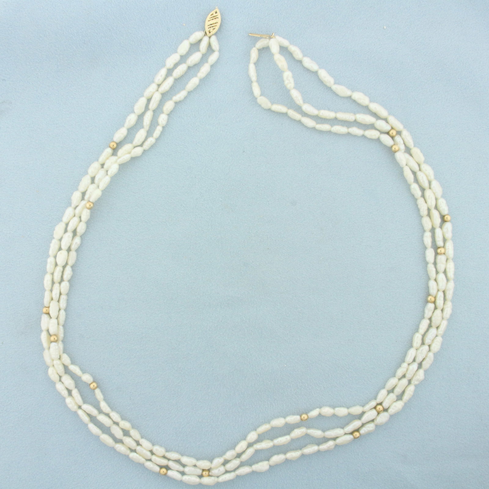 Triple Strand Baroque Pearl and Gold Bead Necklace in 14k Yellow Gold: In 14k yellow gold. Filigree locking clasp and 3mm gold ball beads. Freshwater pearls are approx. 6x3mm each. 18 inches long. 21.0g.