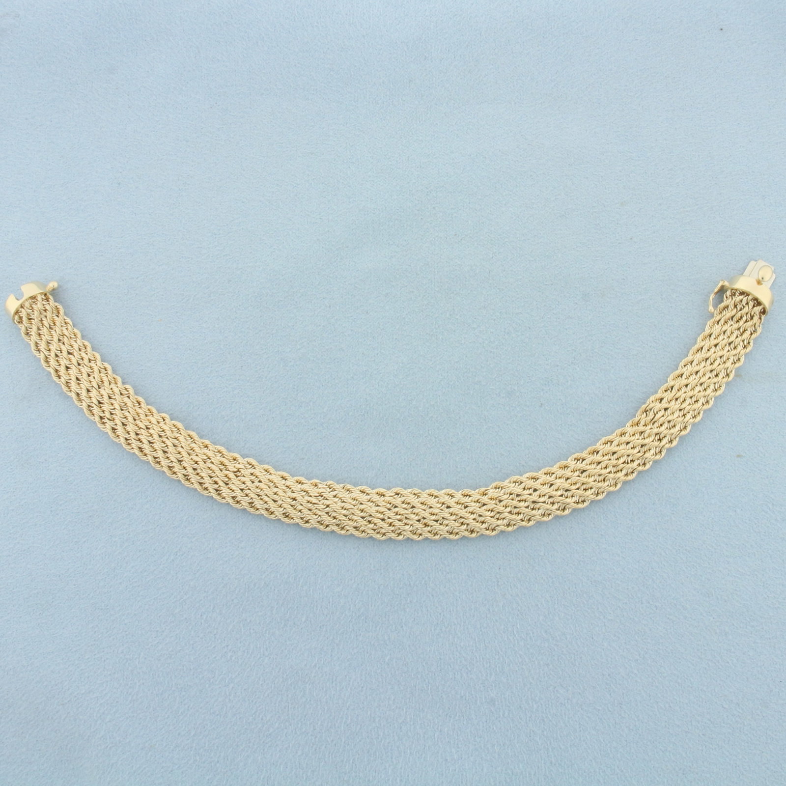 Wide Rope Link Bracelet in 14k Yellow Gold: In 14k yellow gold. 7 5/8 inches long and 3/8 inches wide. Slide clasp with safety latch. 9.4g.