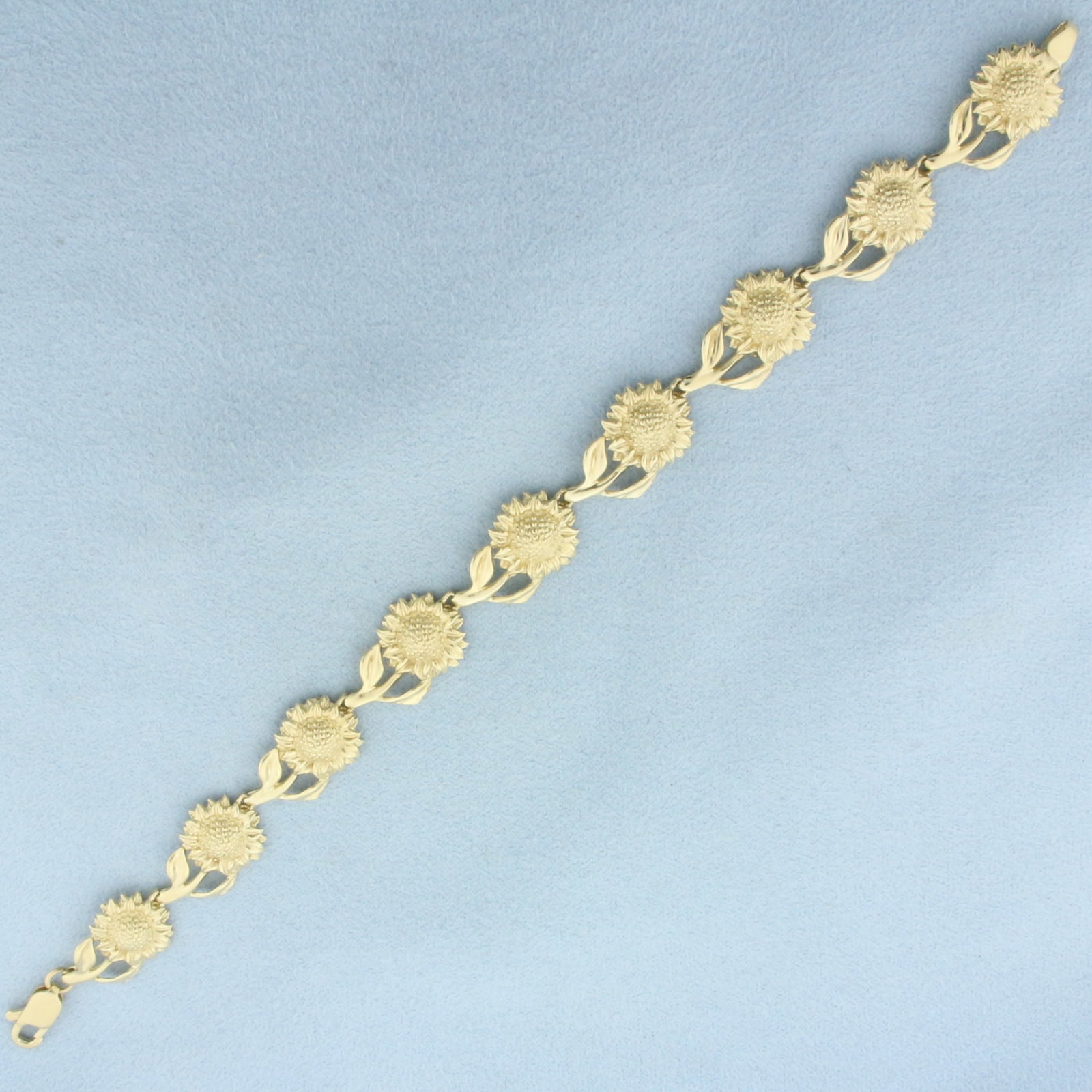 Sunflower Link Bracelet in 14k Yellow Gold: In 14k Yellow Gold. 7 1/2 inches long. 5/8 inch wide. Lobster clasp. 12.5g.