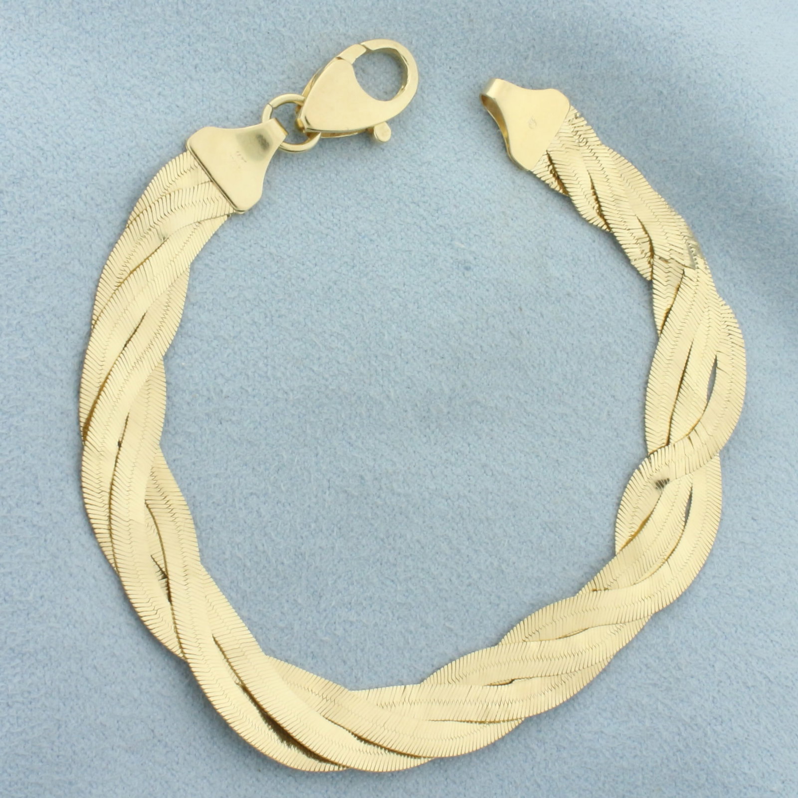 Italian Braided Herringbone Link Bracelet in 14k Yellow Gold: In 14k Yellow Gold. 7 3/4 inches long. 3/8 inch wide. Oversized lobster clasp. 8.5g.