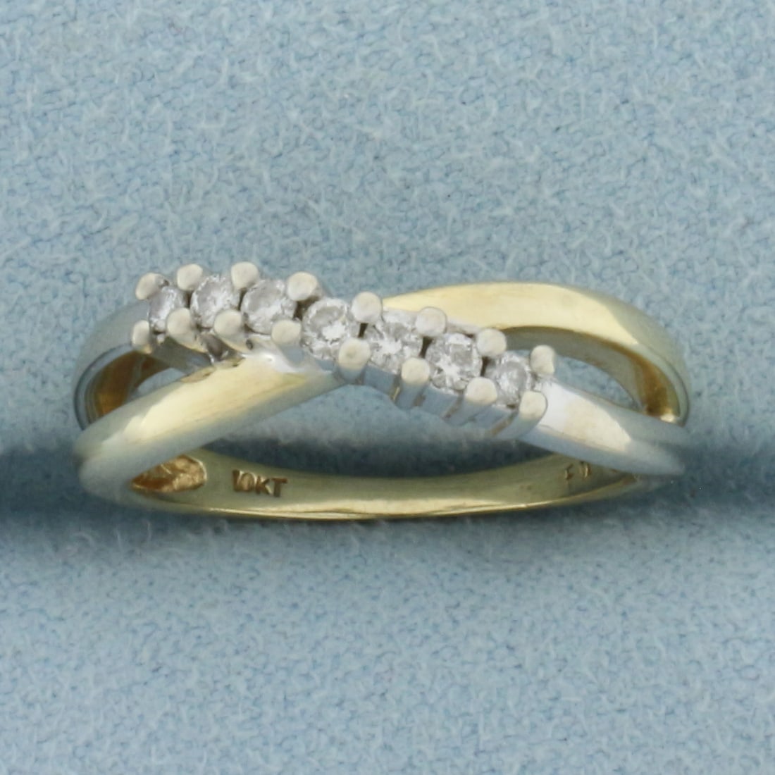 Two Tone Diamond Criss Cross Ring in 10k Yellow and White Gold: In 10k Yellow and White Gold. Contains seven .02ct high quality diamonds, I color/I clarity. 5mm wide at widest point. Size 5.5. 2.7g.
