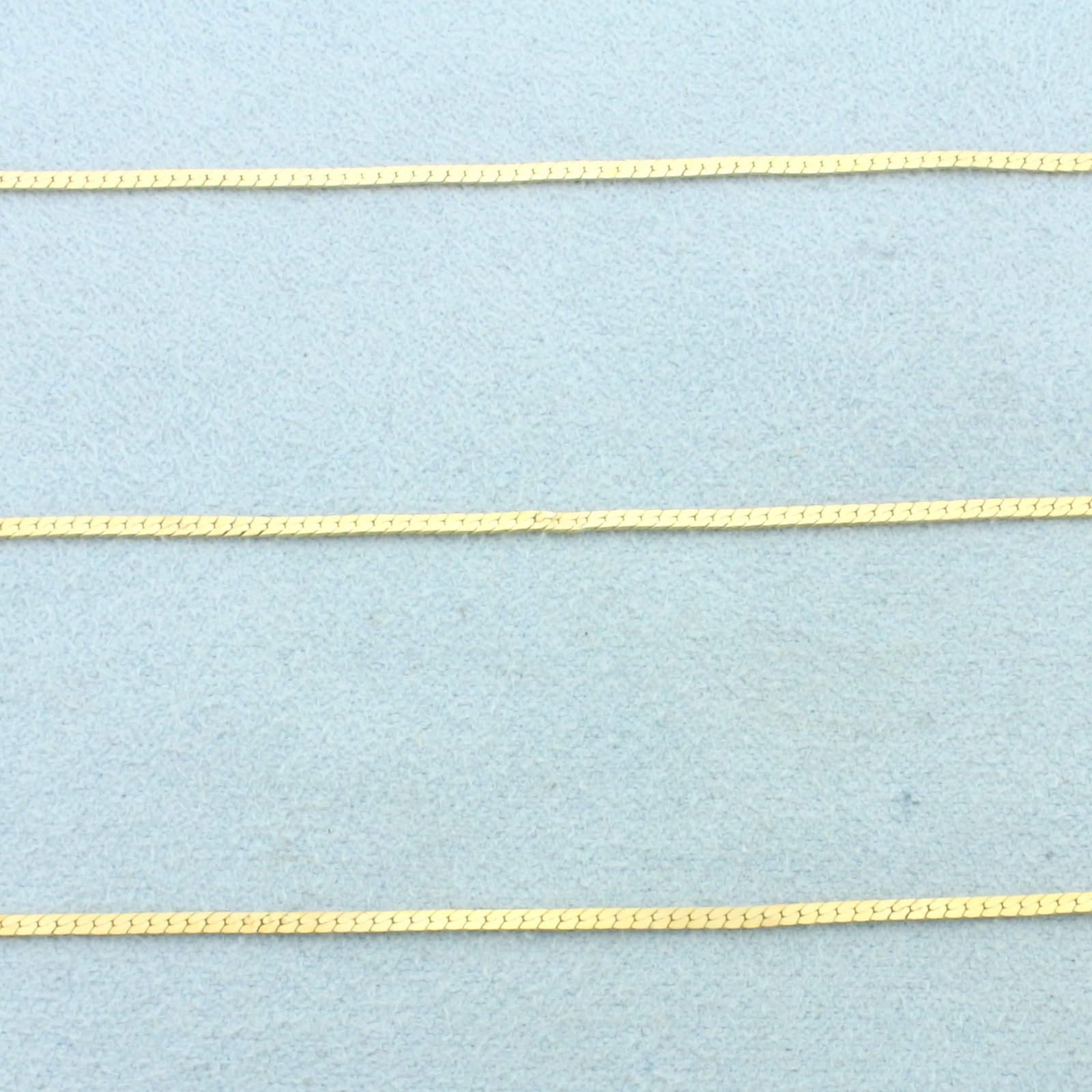 Italian 30 Inch Herringbone Link Chain Necklace in 14k Yellow Gold: In 14k Yellow Gold. 30 inches long. 1.5mm wide. Herringbone link. Made in Italy. Spring clasp. 3.3g.