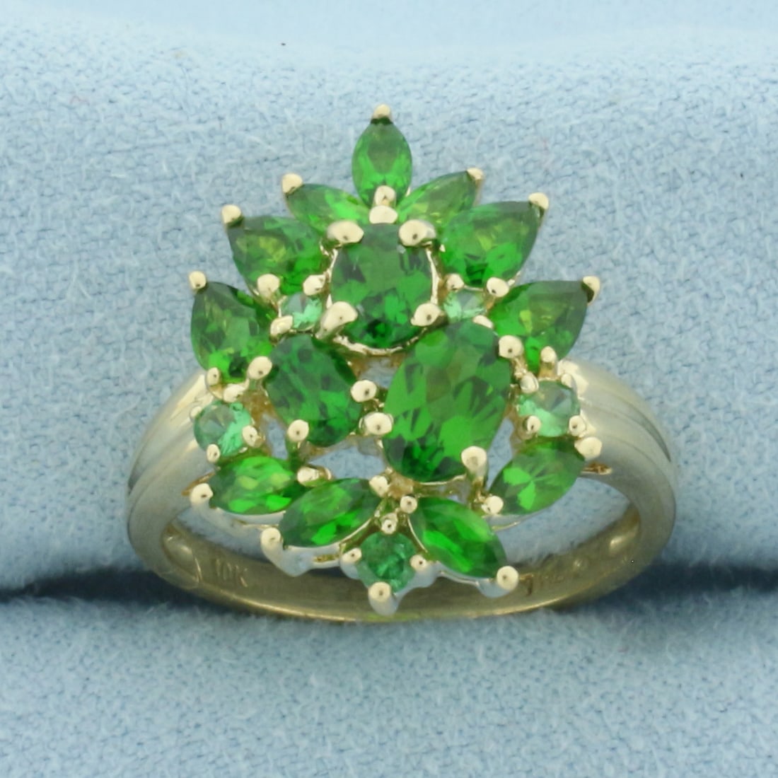 Green Garnet Ring in 10k Yellow Gold: In 10k Yellow Gold. Contains one 6x4mm oval, one 5x3.5mm oval, one 4x3mm oval, four 4x3mm pear, seven 4x2mm marquise, three 2mm round, and two 1.5mm round high quality natural Green Garnet gemstones w