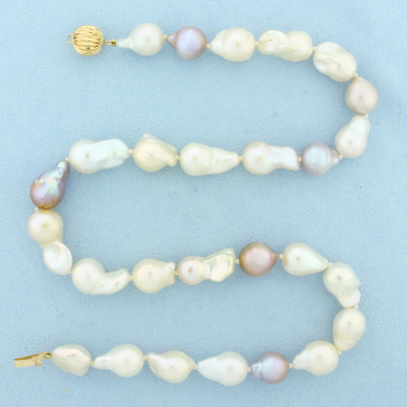 Baroque Multi Color Akoya Pearl Necklace in 14k Yellow Gold: In 14k Yellow Gold. 18 inches long. Contains 11mm high quality baroque Akoya pearls with high luster and beautiful colors including cream, silver, and peacock. Hand knotted. Decorative bead clasp. 60.