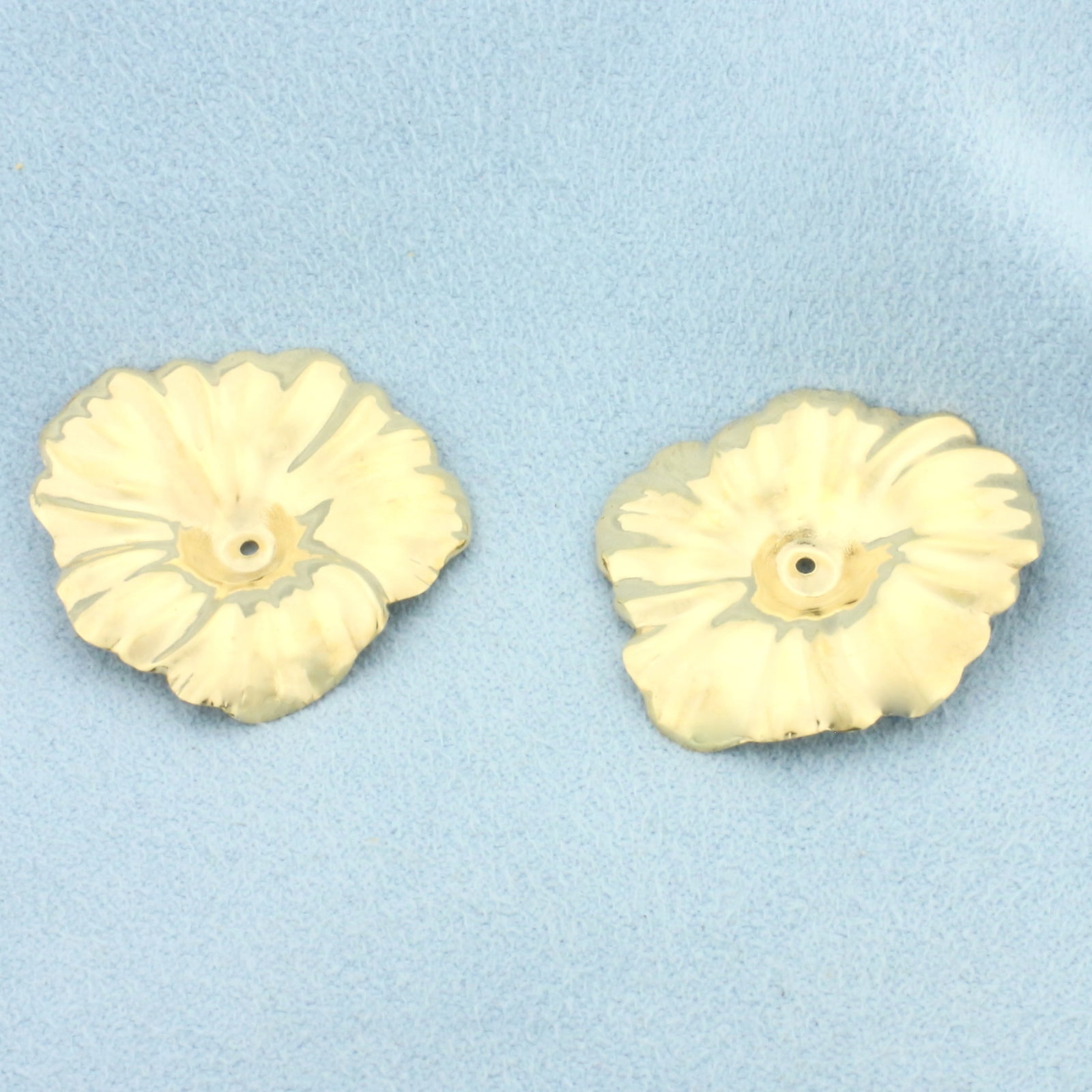 Leaf Design Stud Earring Enhancer Jackets in 14k Yellow Gold: In 14k Yellow Gold. 1 inch long. 3/4 inch wide. Designed to fit around stud earrings to give a fresh new look. 1.5g.